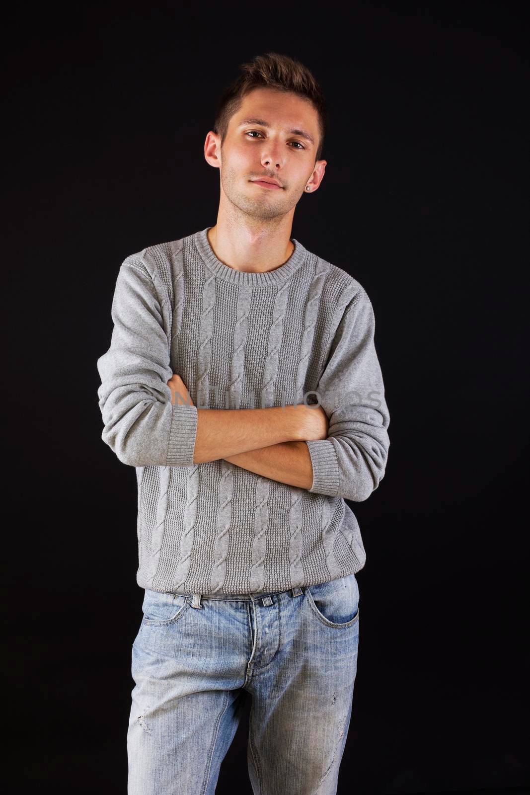 Handsome male portrait, isolated against black background