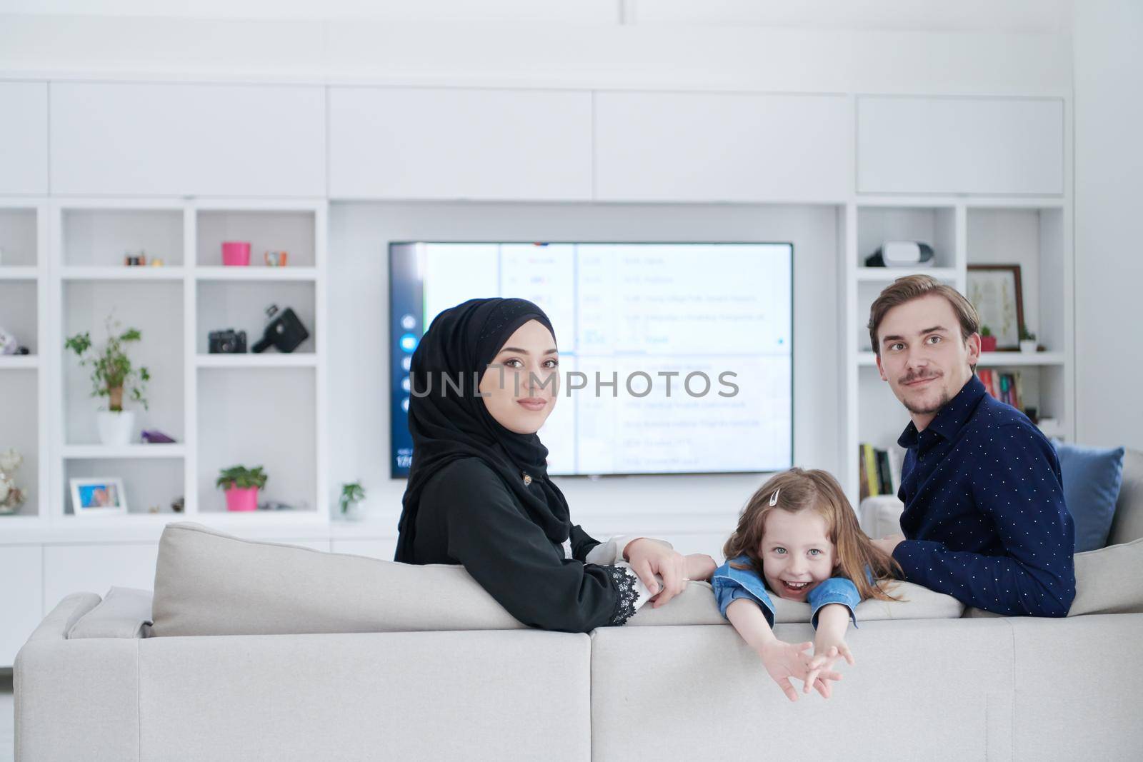 Happy Muslim family having fun at home by dotshock