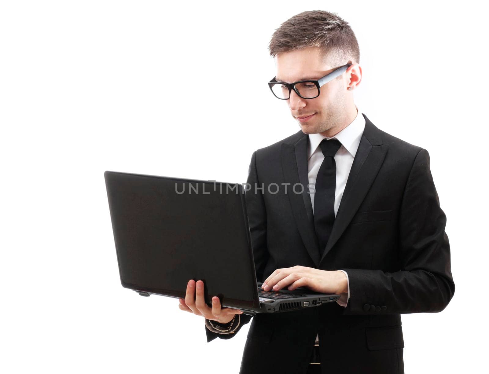 Businessman holding a laptop and smiling. Isolated against a white background.