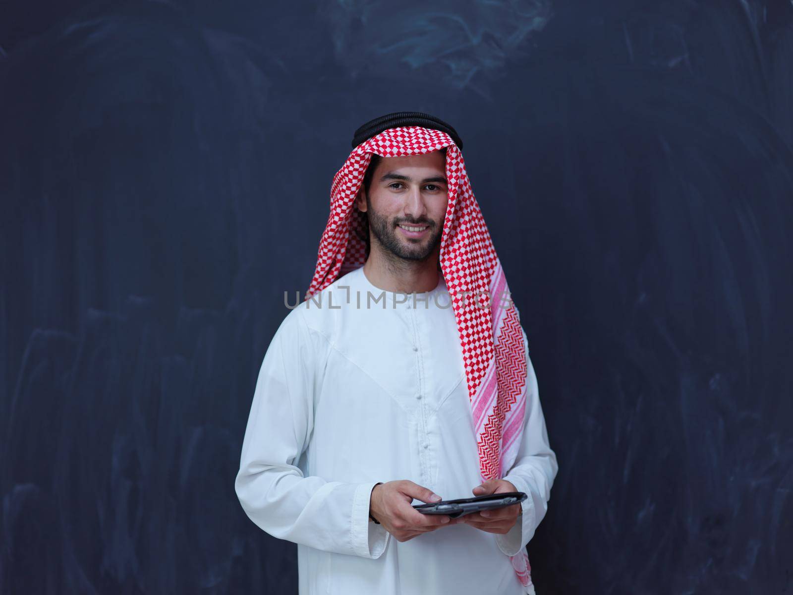young arabian muslim businessman using tablet computer by dotshock