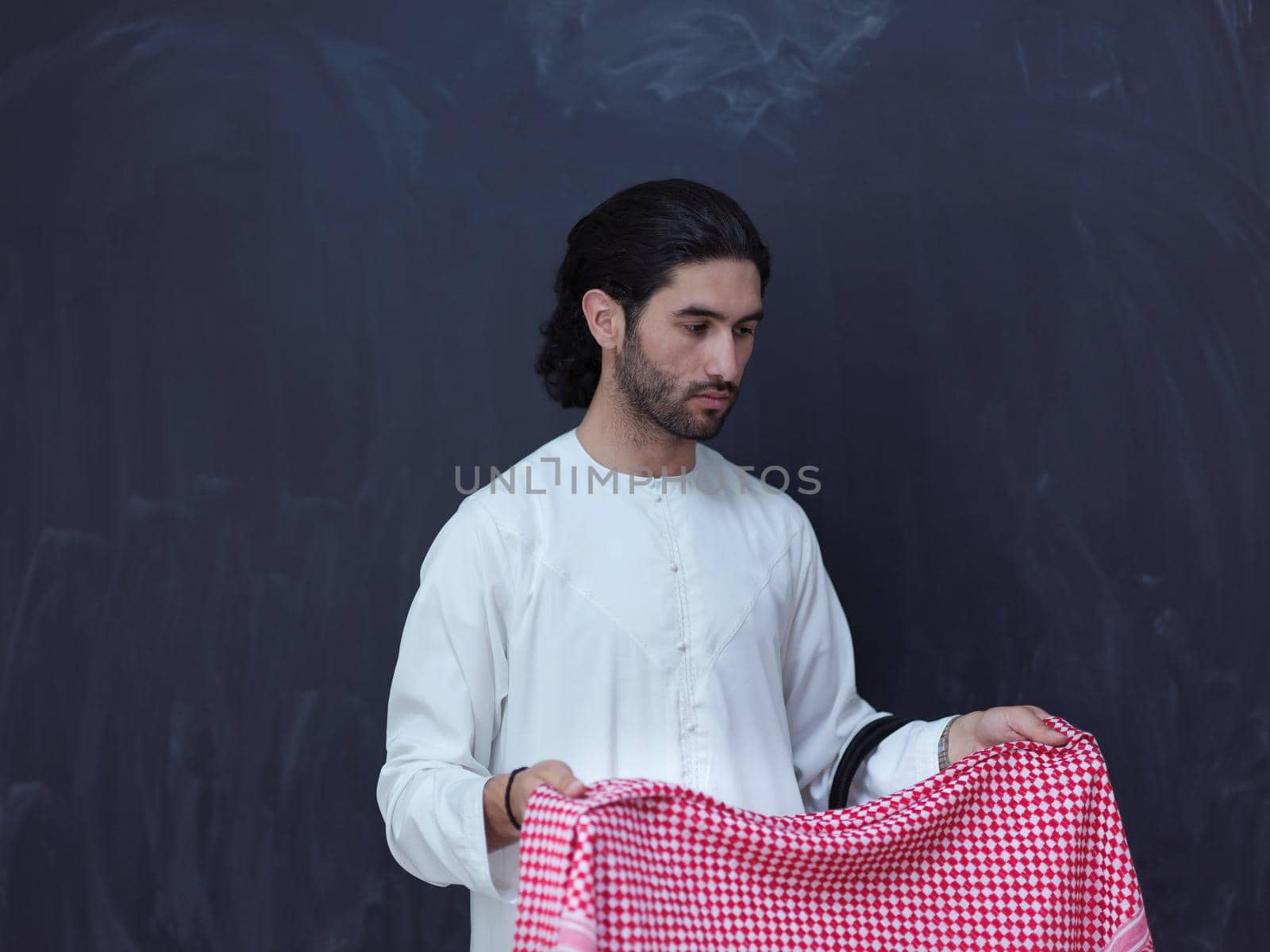 portrait of arabian man in front of black chalkboard by dotshock