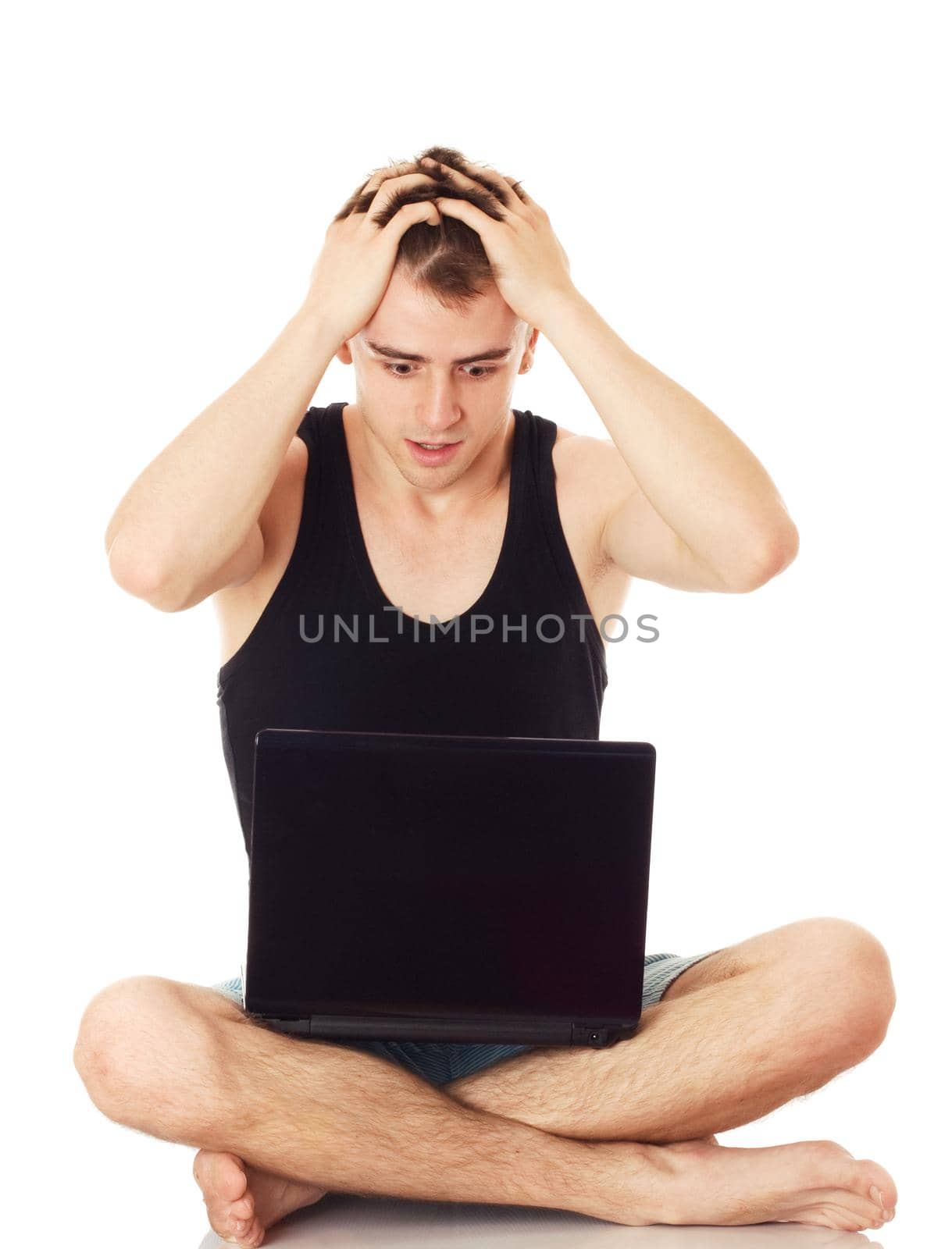 Full isolated studio picture from a man despairing with his computer.