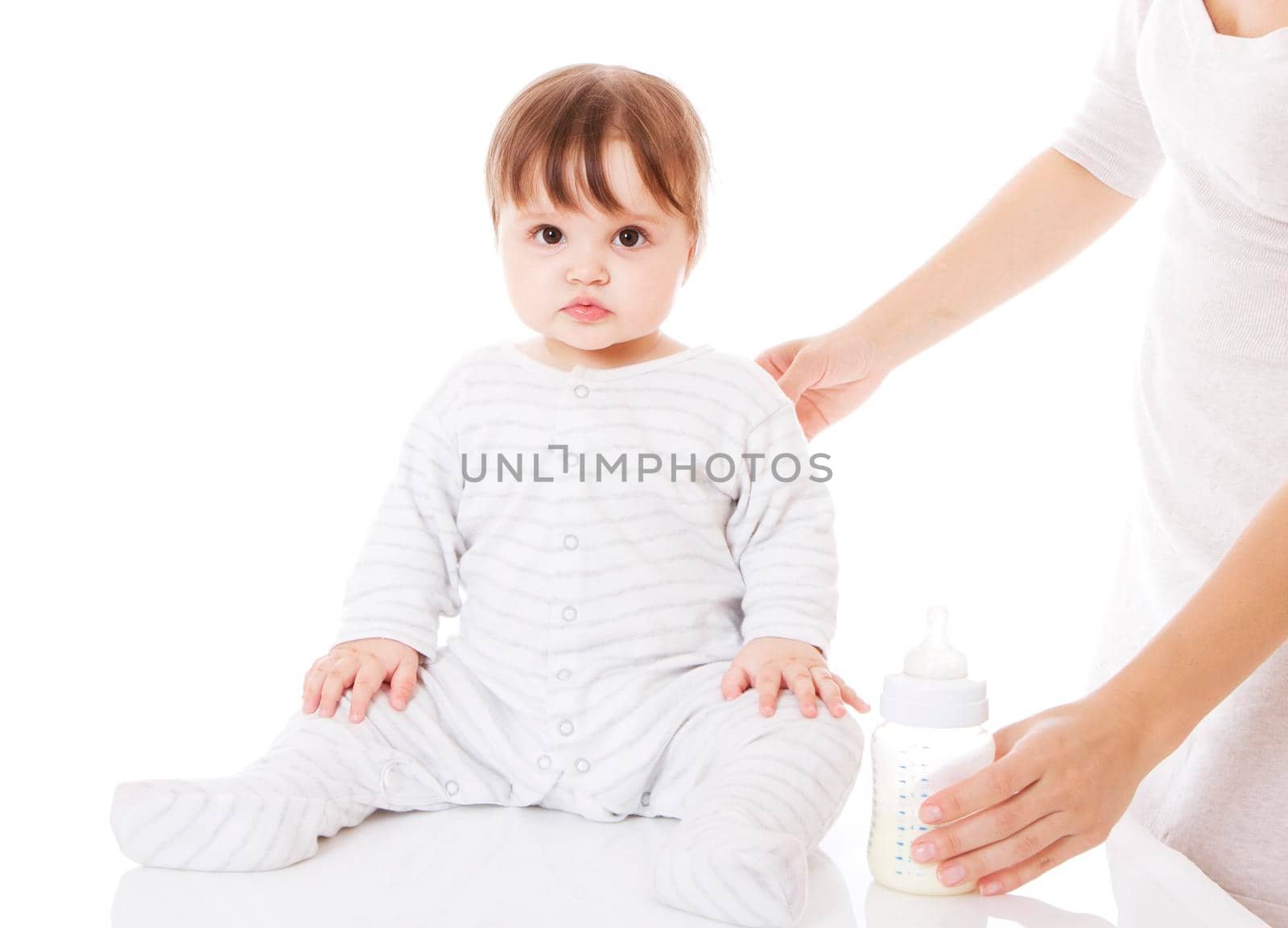 Mother feeding her newborn baby with the bottle. Isolsted on white.