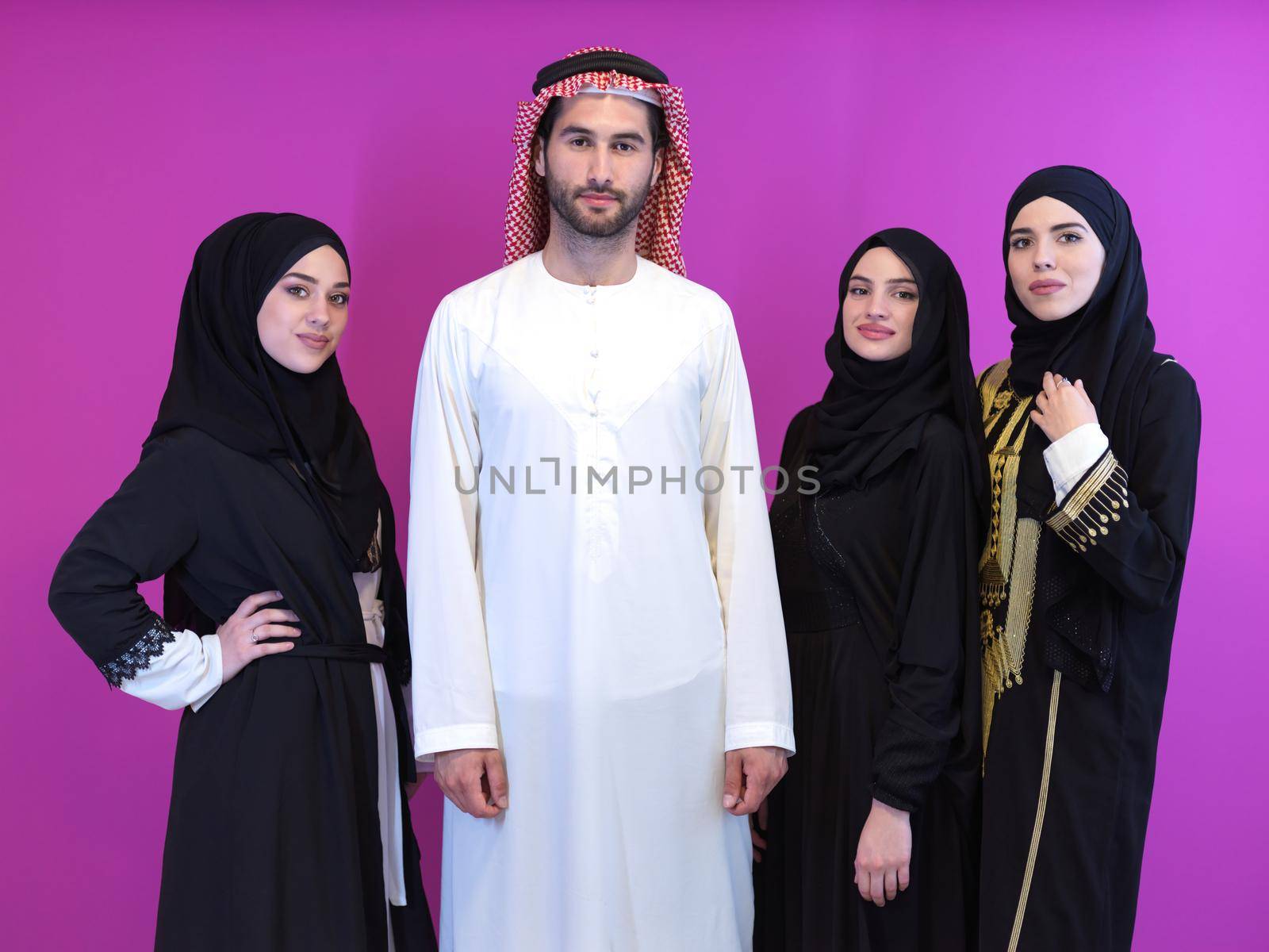 portrait of young muslim people isolated on pink by dotshock