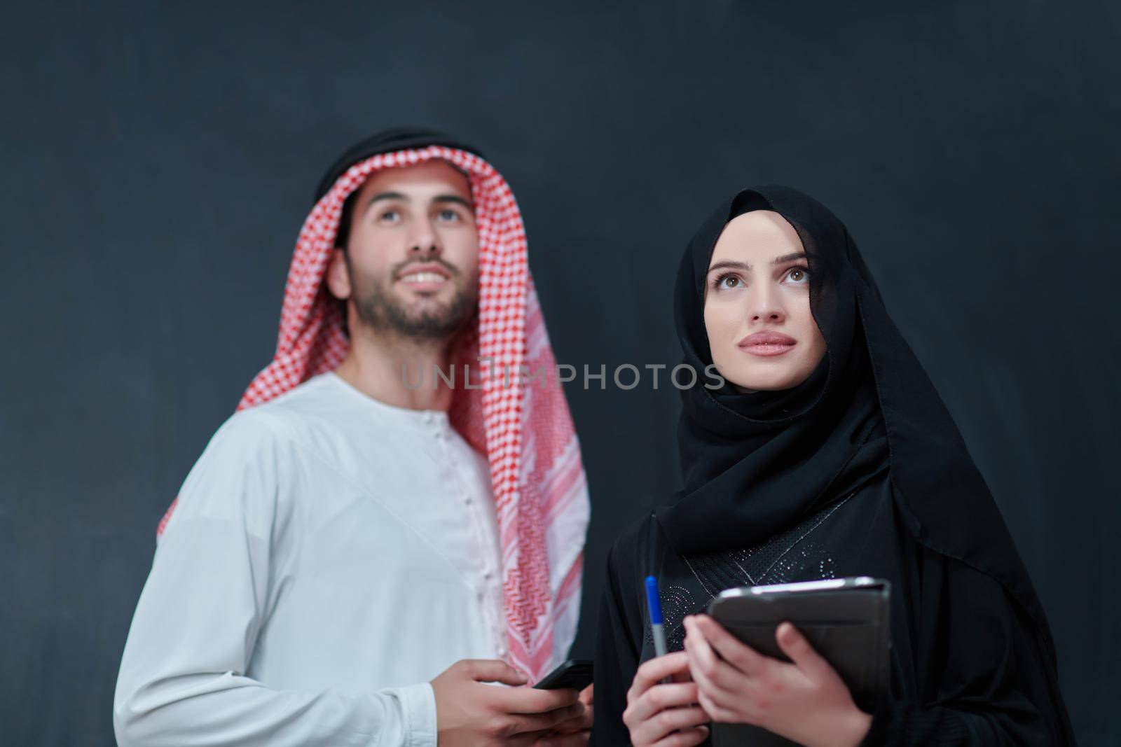 Young muslim business couple using technology devices by dotshock