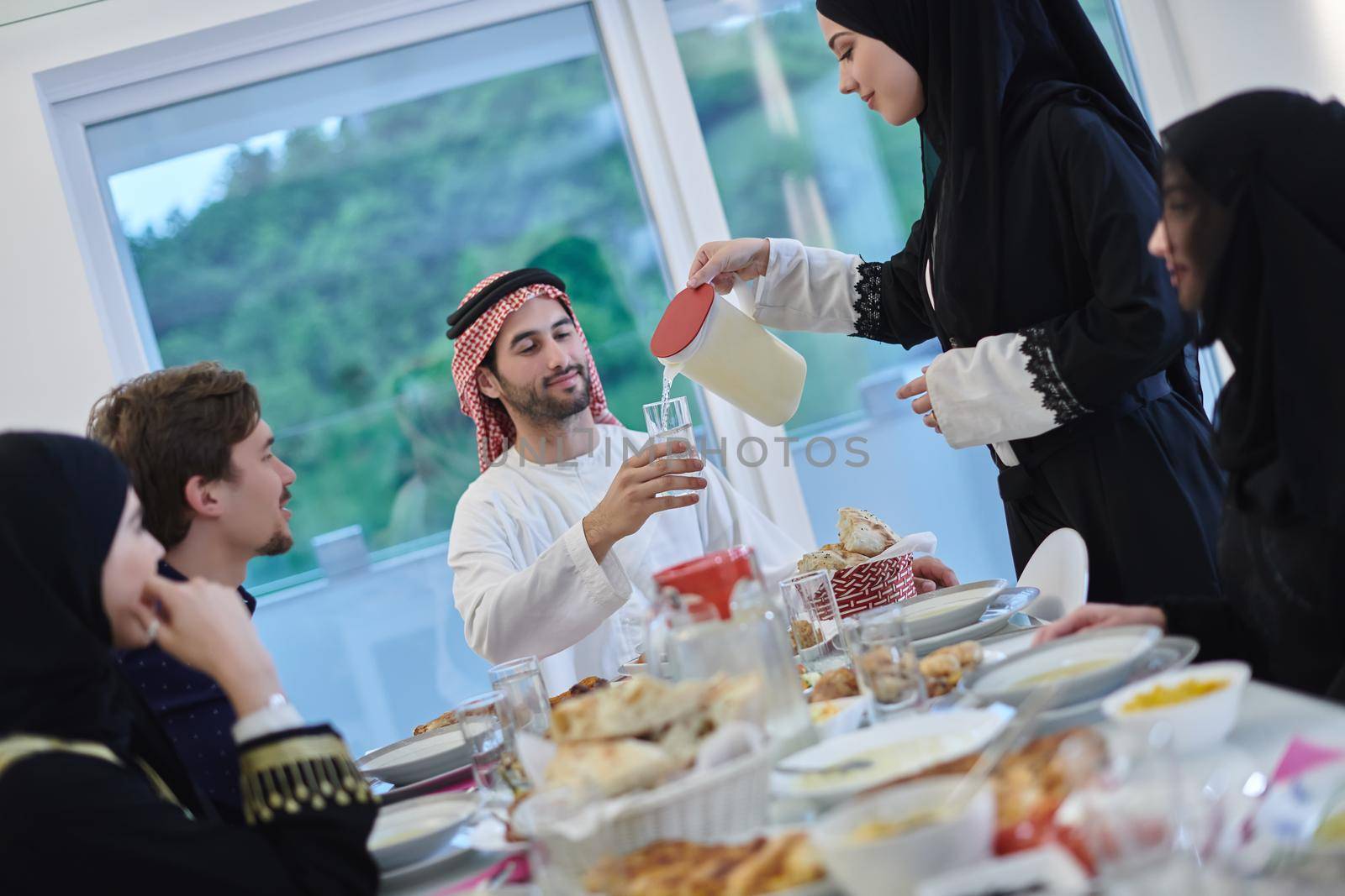 Muslim family having iftar together during Ramadan by dotshock
