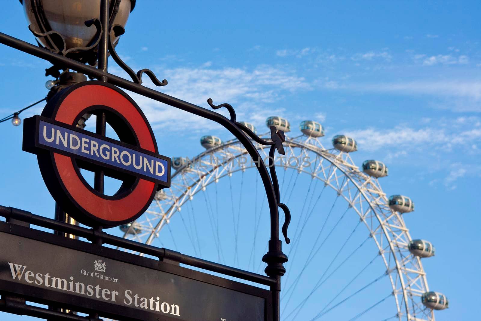 The Westminster sign and the London eye blue sky