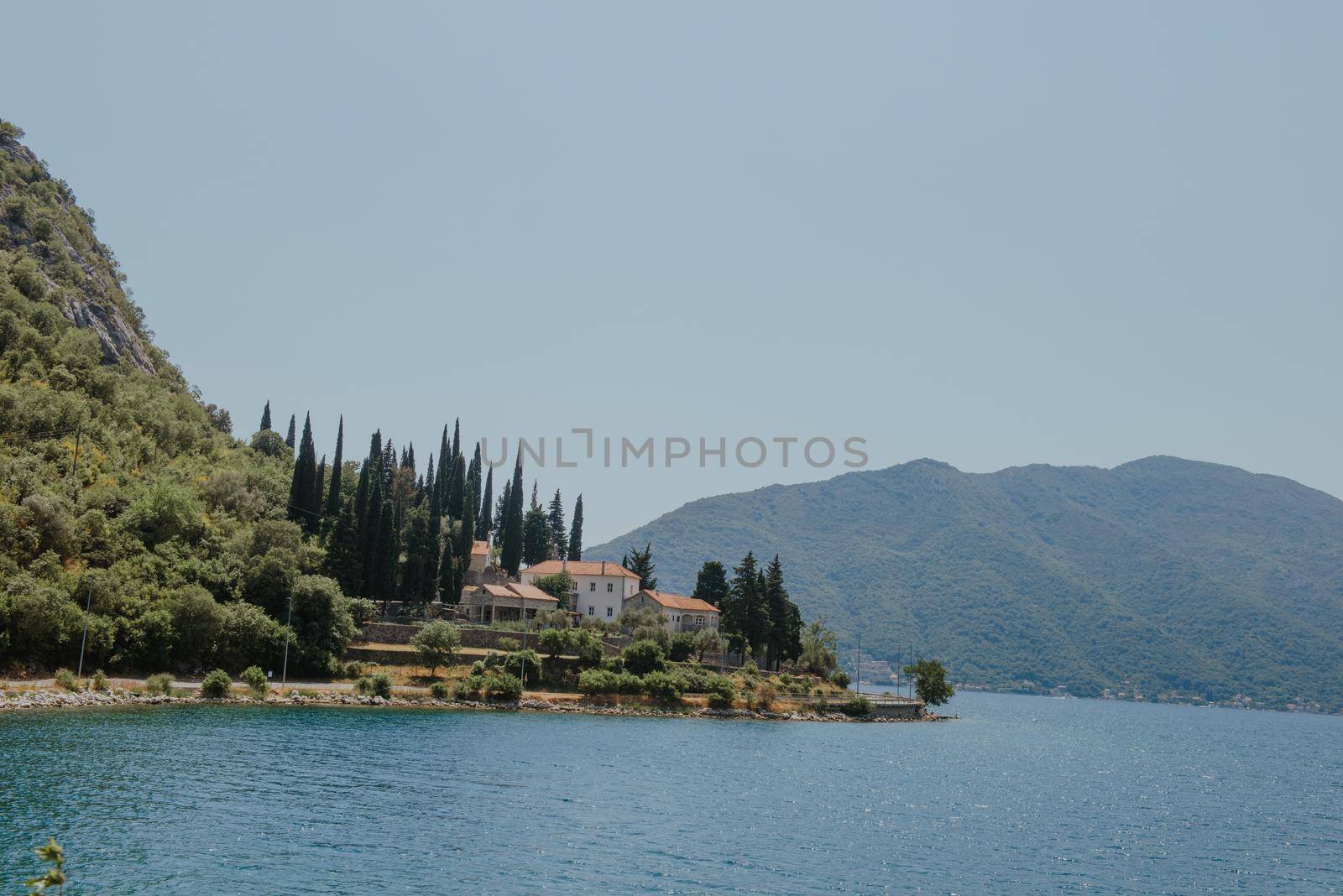 Blue boat in Bay of Kotor of Adriatic Sea, Montenegro. Beautiful view of the natural landscape. shore of Kotor. Scenic summer resort landscape. summer rest, vacation.