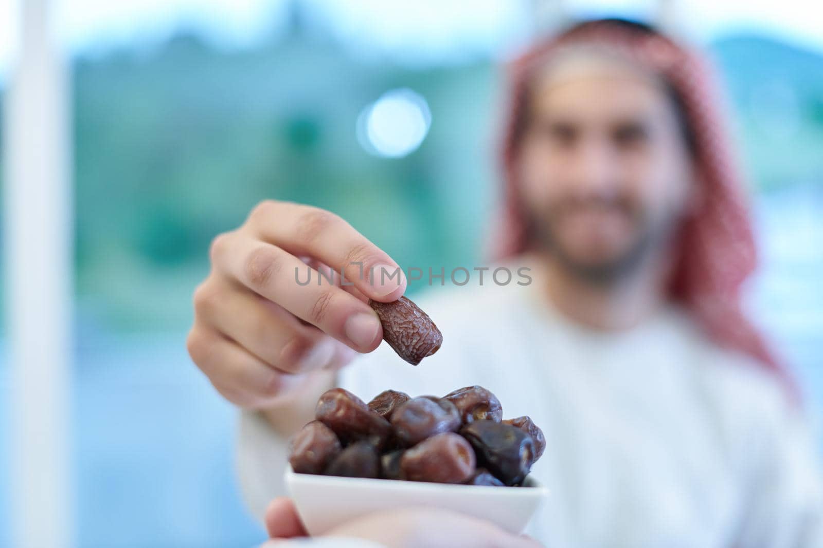 Muslim couple sharing dates for starting iftar by dotshock