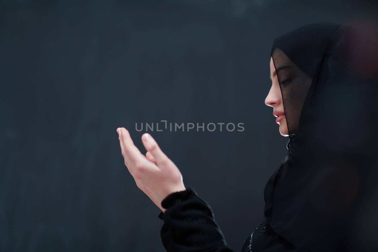Portrait of young Muslim woman making dua by dotshock