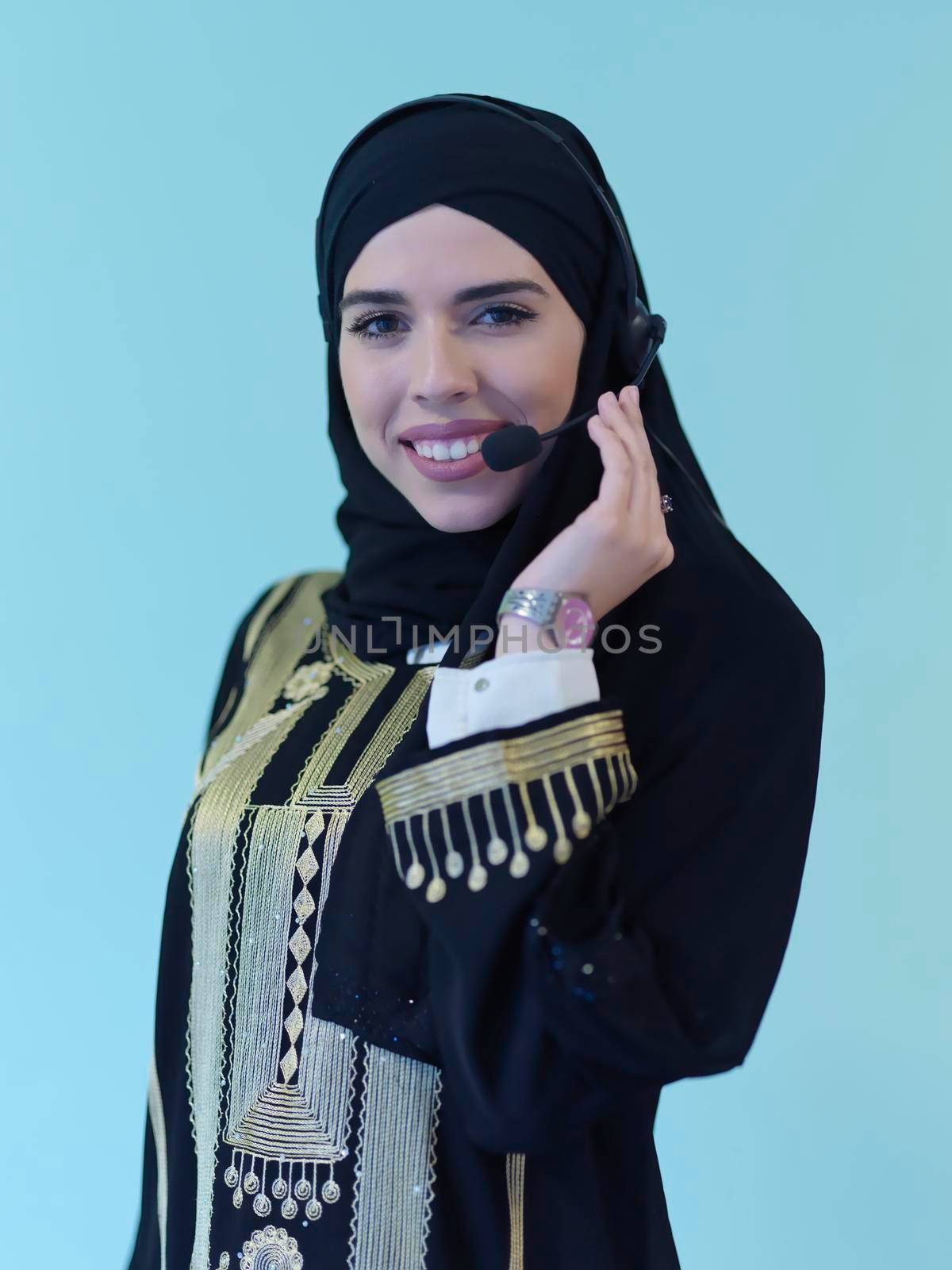 Portrait of young muslim woman with headphones by dotshock