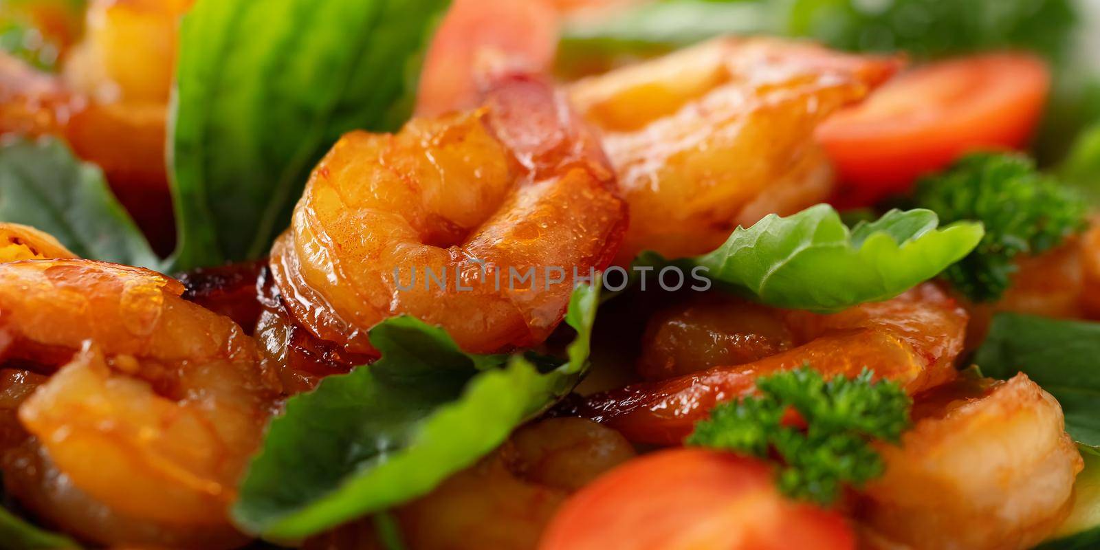 Close-up of fresh shrimp, tomato, arugula and greens salad, horizontal banner by galsand