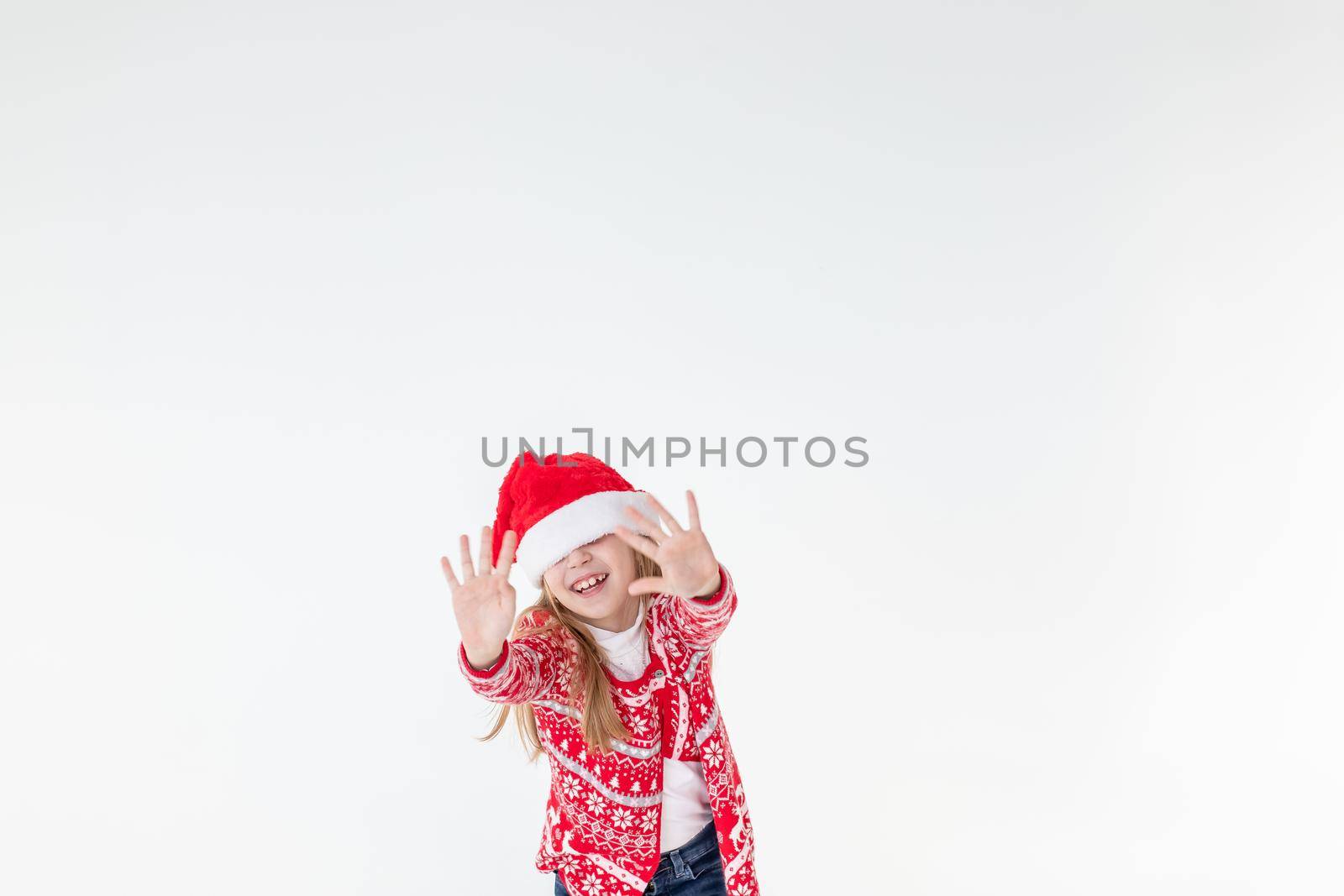 Photo portrait of kid dancing keeping hands up over head wearing red christmas sweater isolated on blue color background
