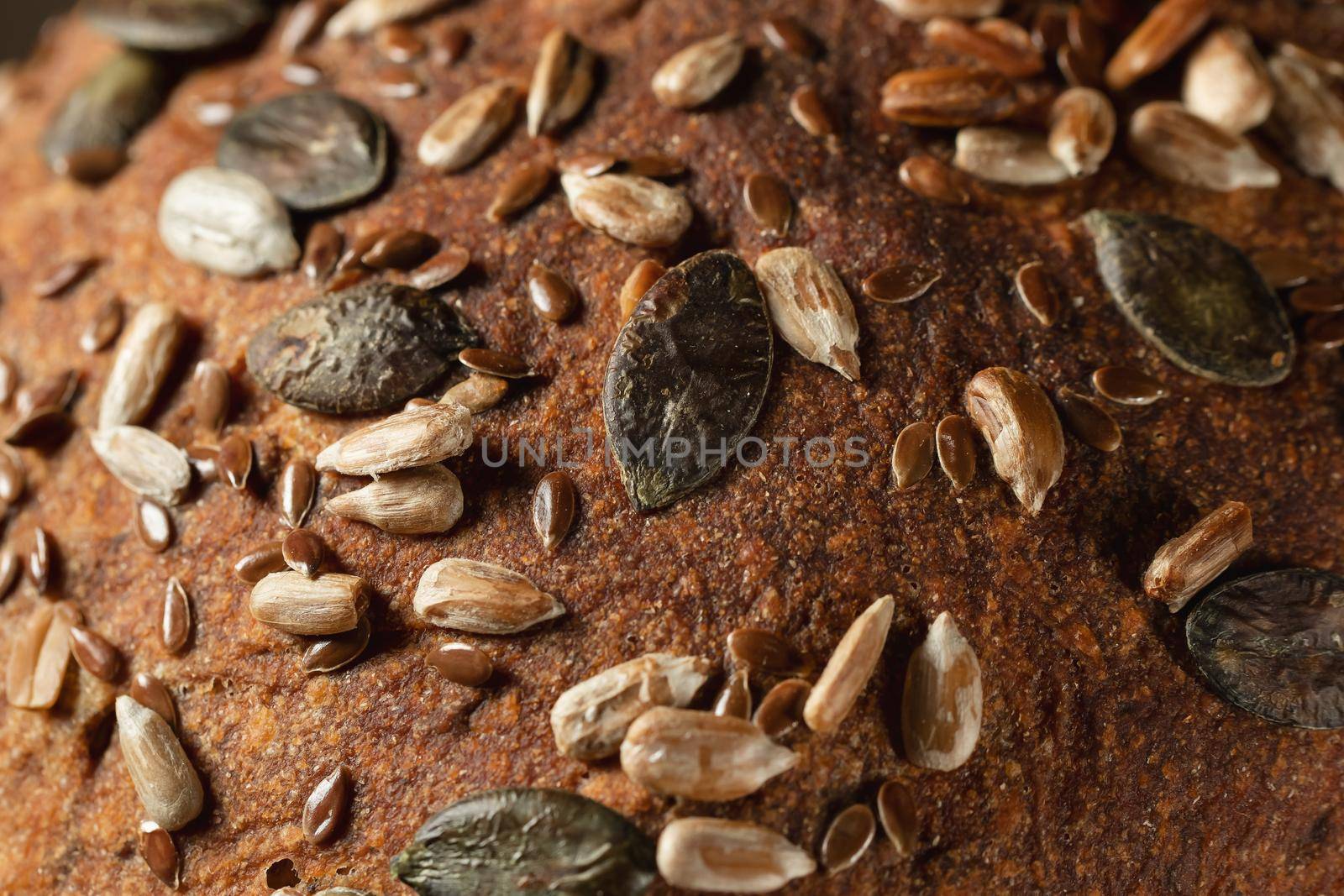 Close-up surface of homemade whole grain bread, food background, texture.