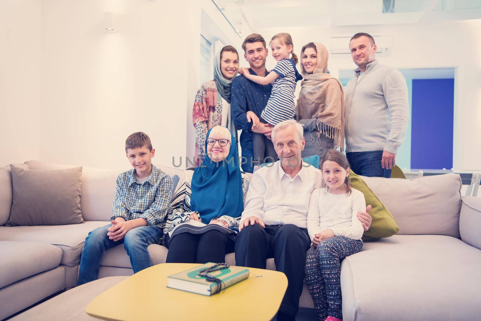 several generations portrait of happy modern muslim family before iftar dinner during ramadan feast at home