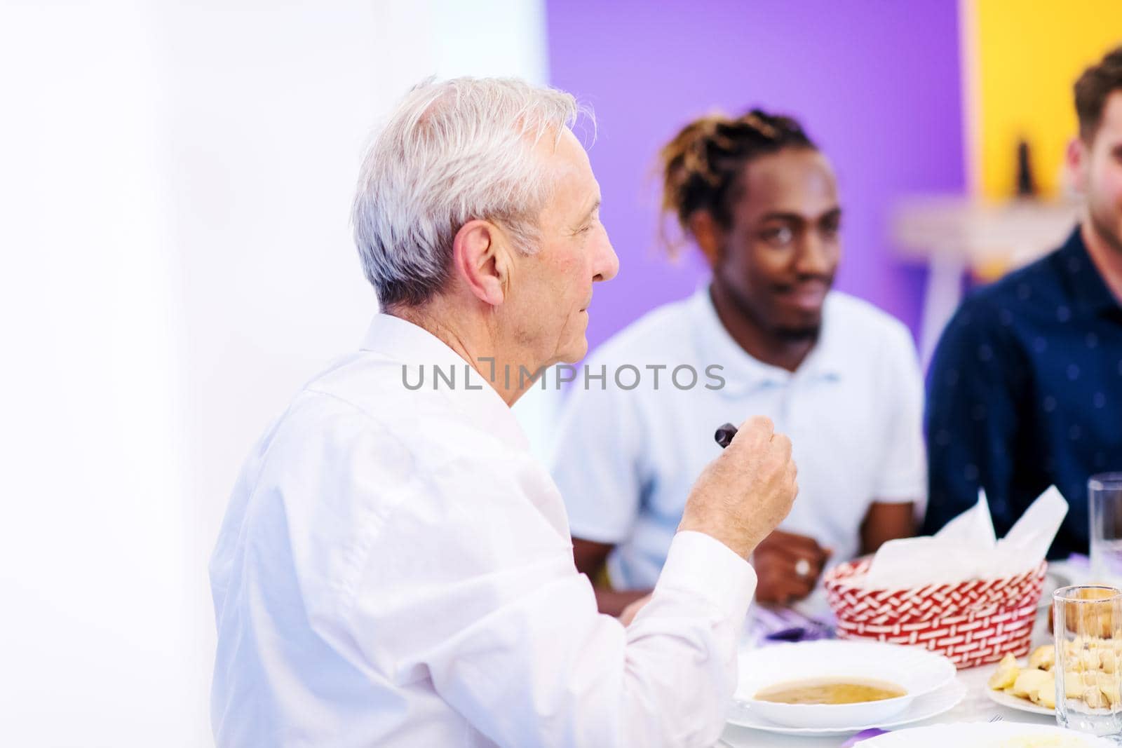 modern multiethnic muslim family sharing a bowl of dates while enjoying iftar dinner together during a ramadan feast at home