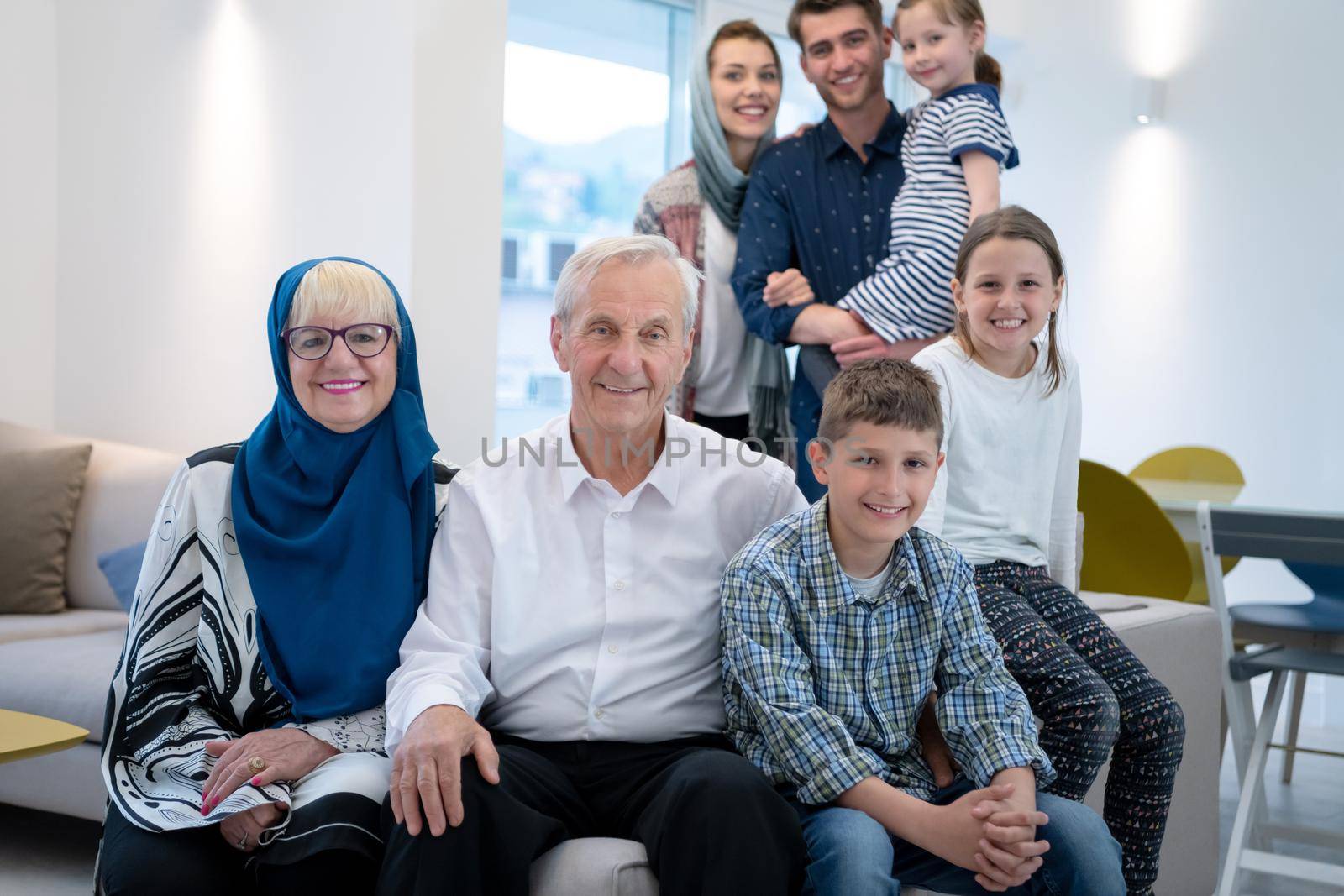 several generations portrait of happy modern muslim family before iftar dinner during ramadan feast at home