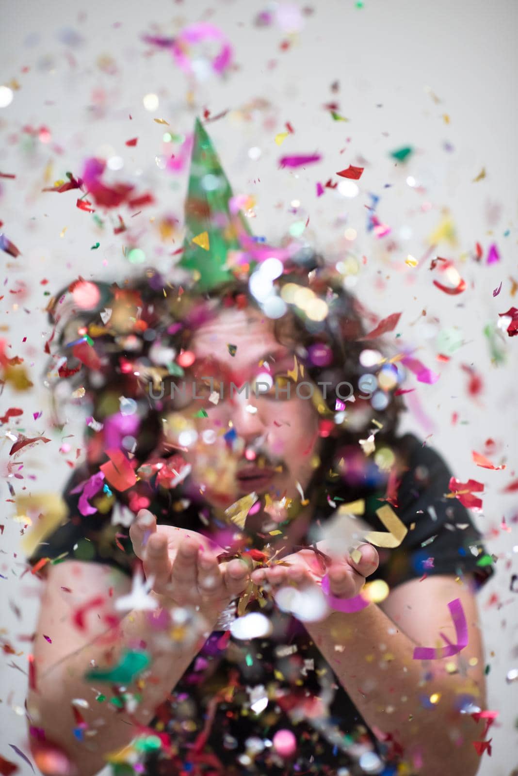 young man on party celebrating new year with falling confetti