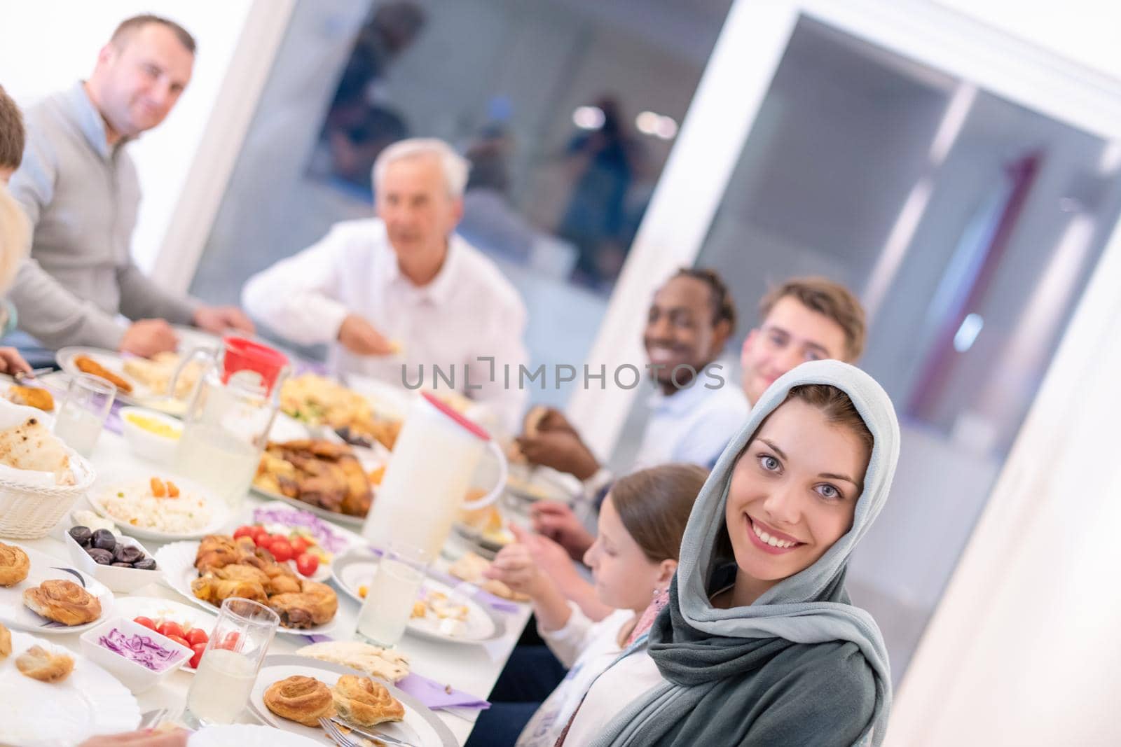 modern multiethnic muslim family enjoying eating iftar dinner together during a ramadan feast at home