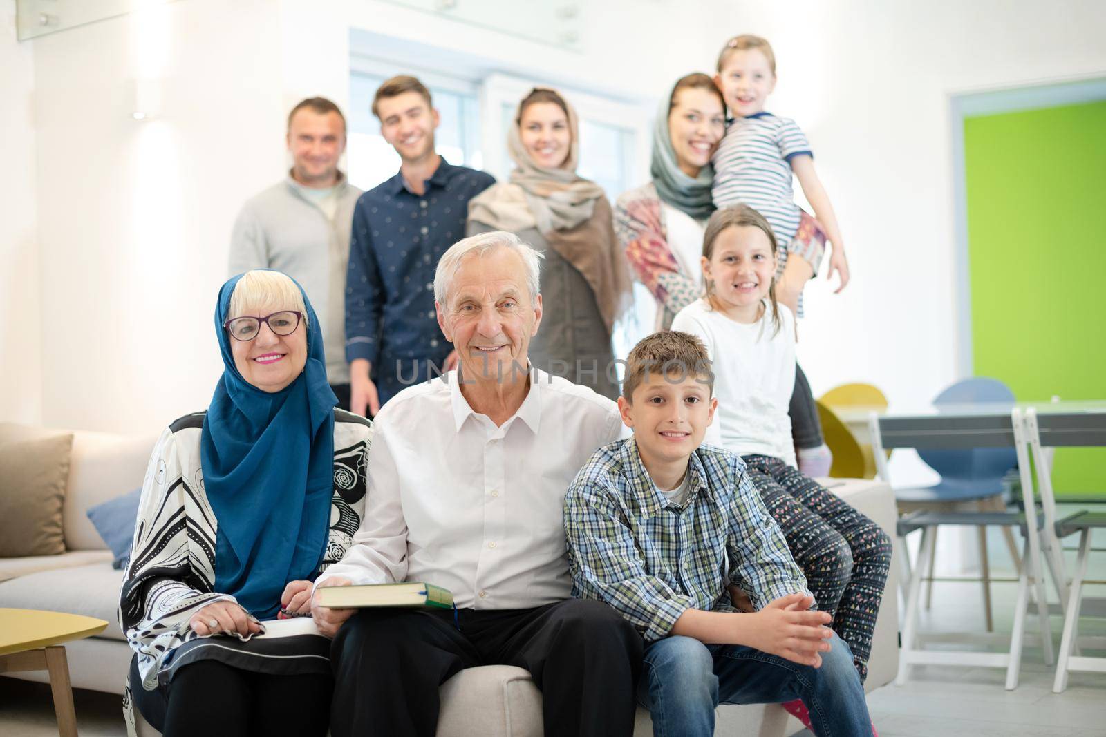 several generations portrait of happy modern muslim family before iftar dinner during ramadan feast at home