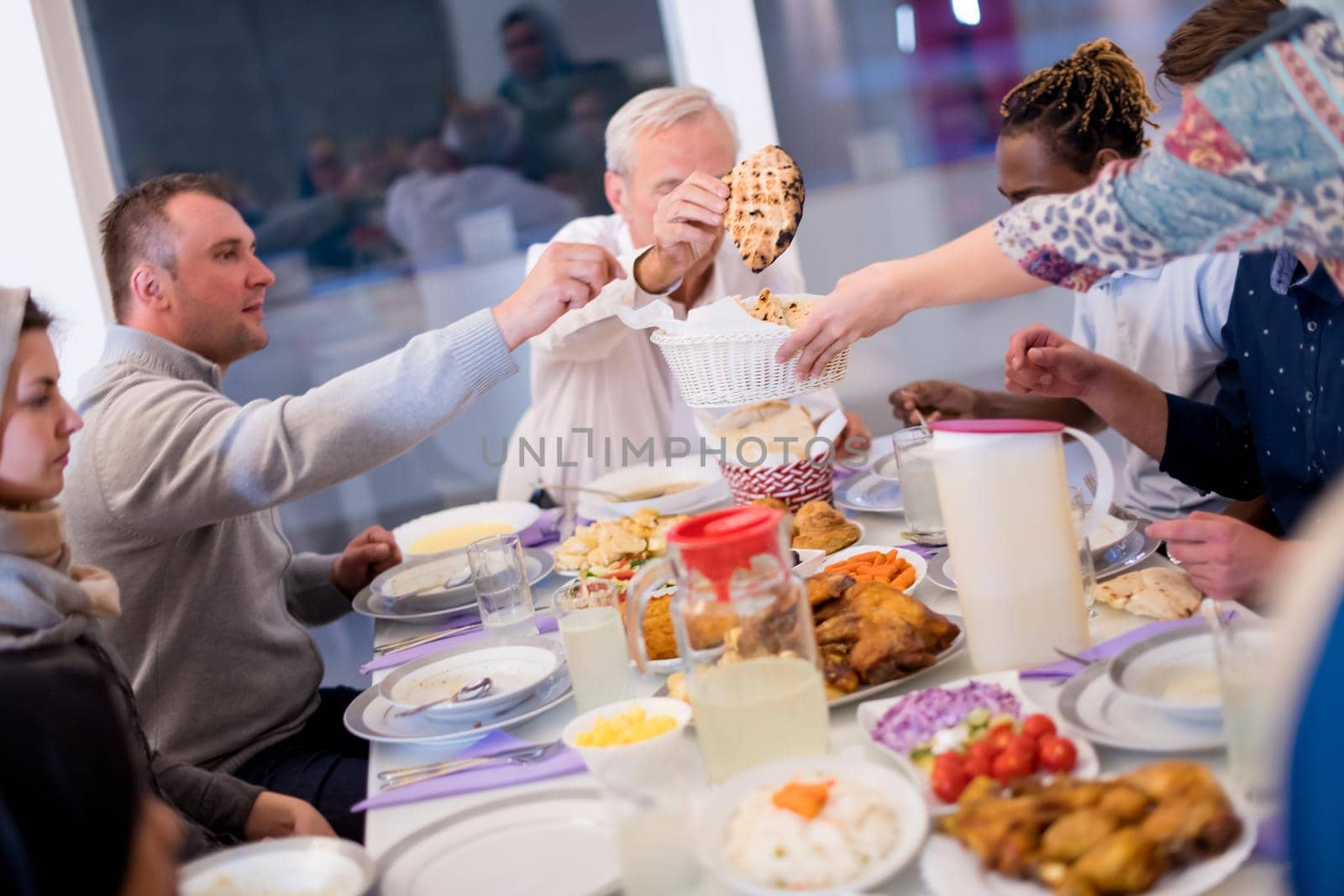 modern multiethnic muslim family having a Ramadan feast by dotshock
