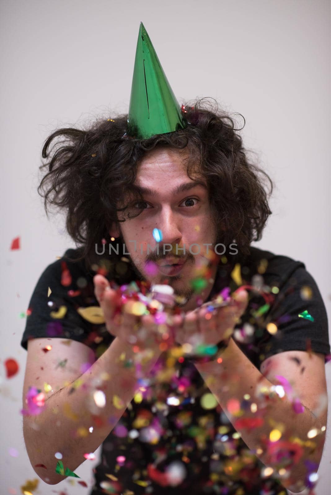 young man on party celebrating new year with falling confetti