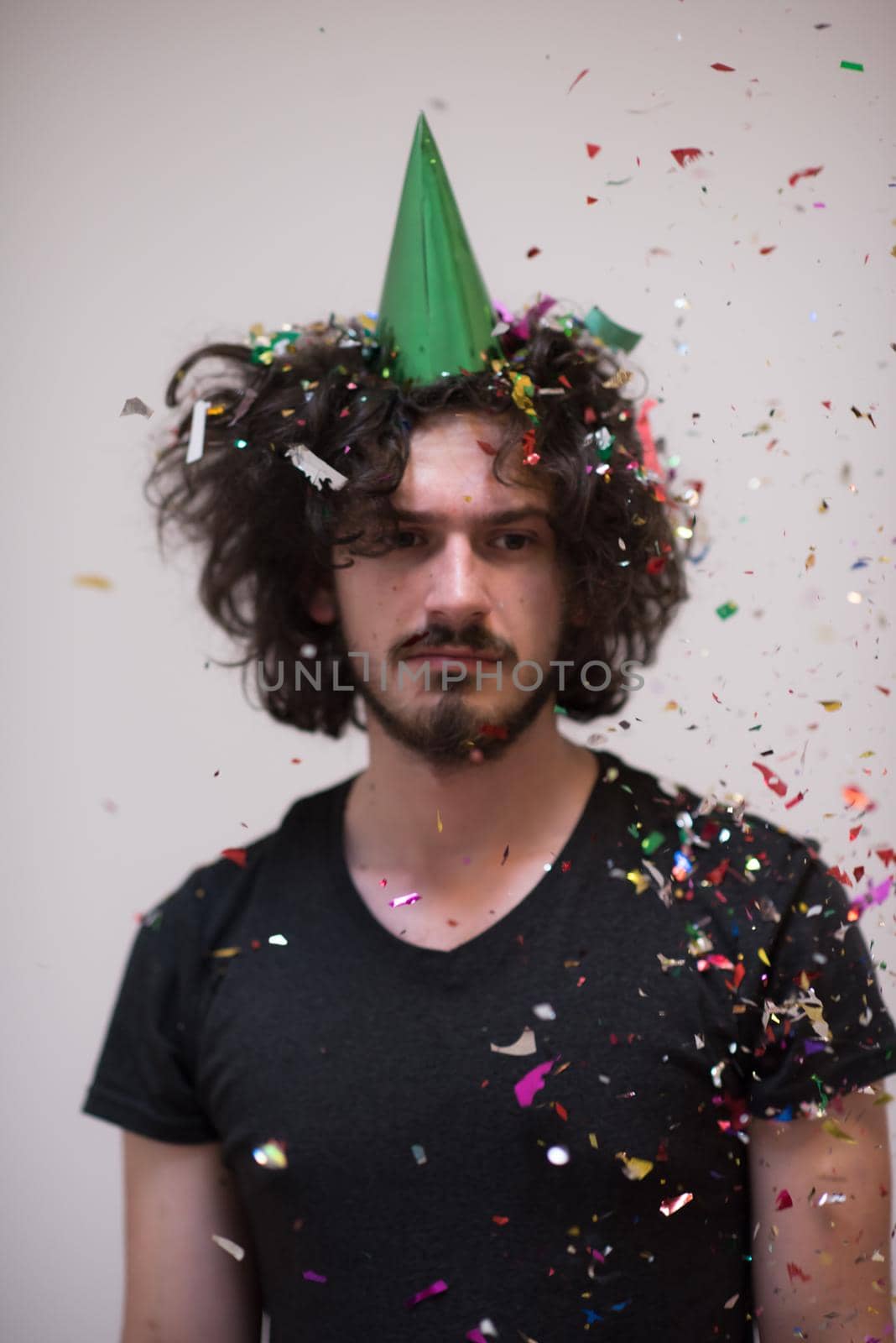 young man on party celebrating new year with falling confetti