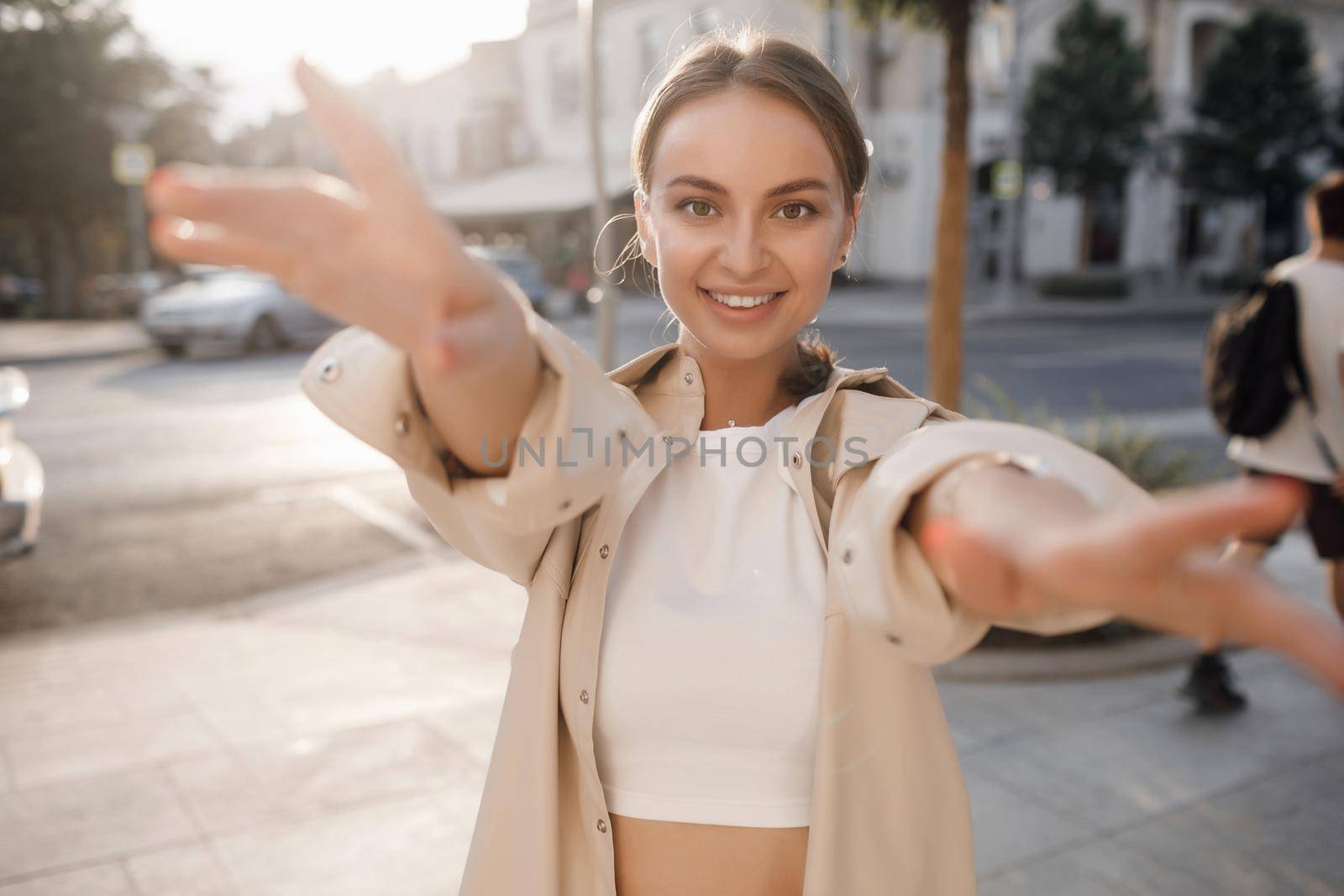 Portrait of a young fashion woman outdoors by splash