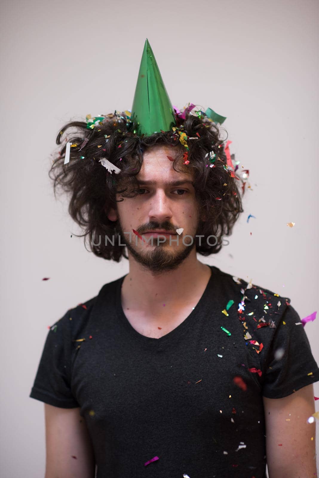 young man on party celebrating new year with falling confetti