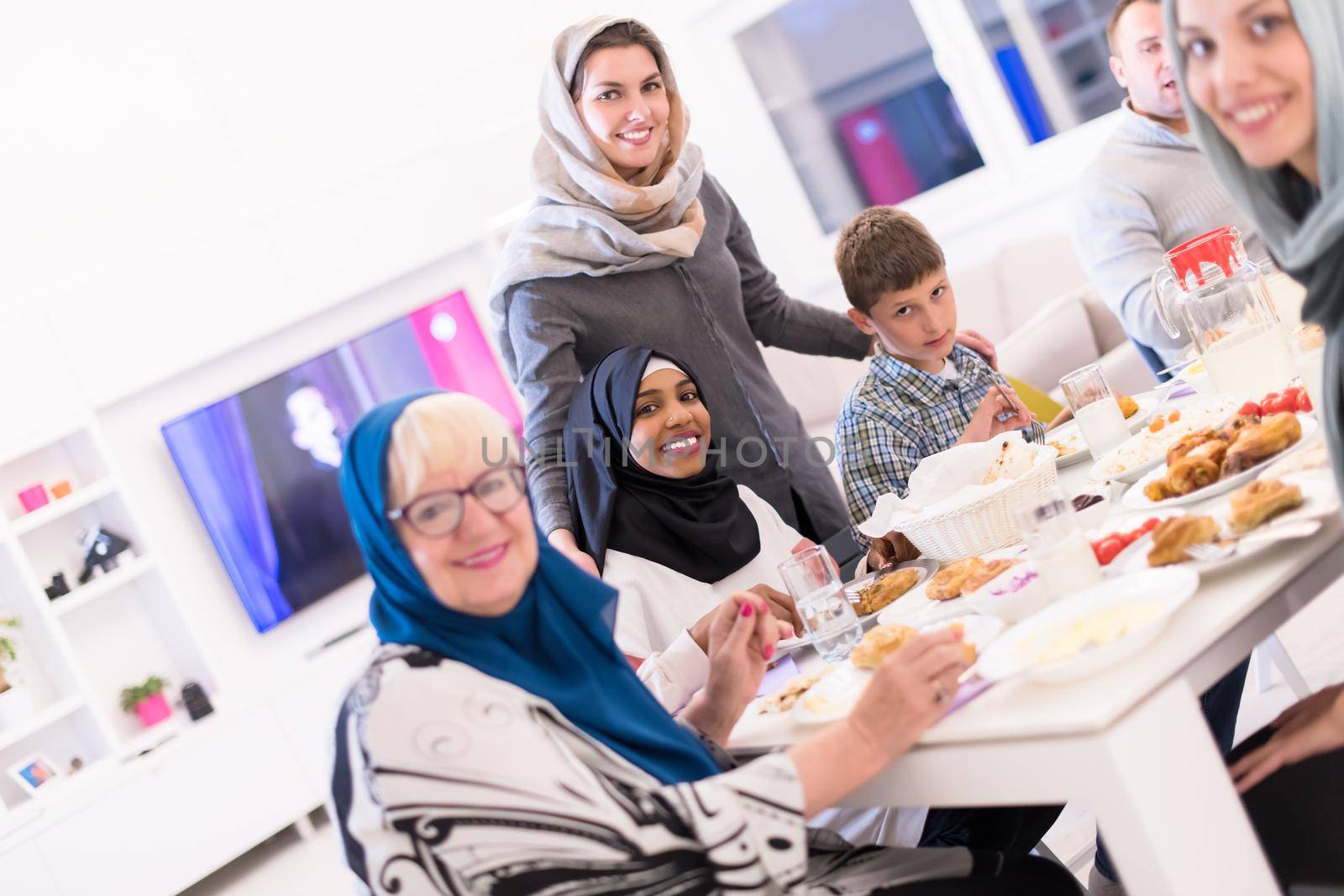 black modern muslim woman enjoying iftar dinner with family by dotshock