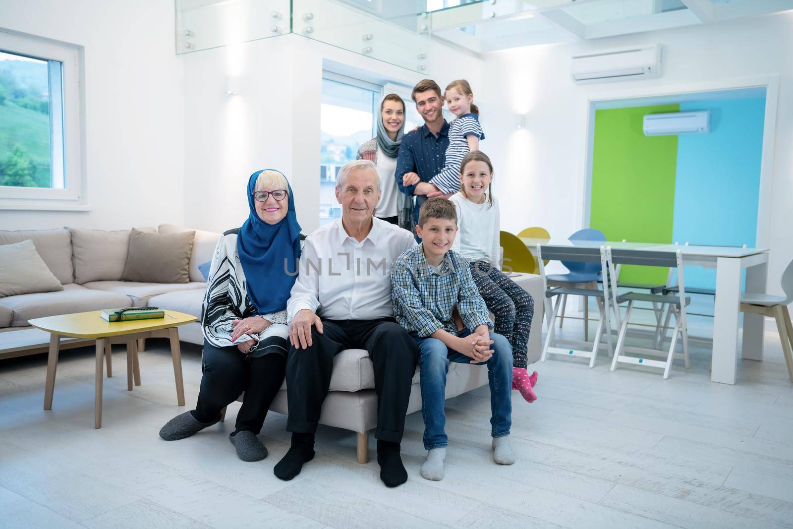 several generations portrait of happy modern muslim family before iftar dinner during ramadan feast at home
