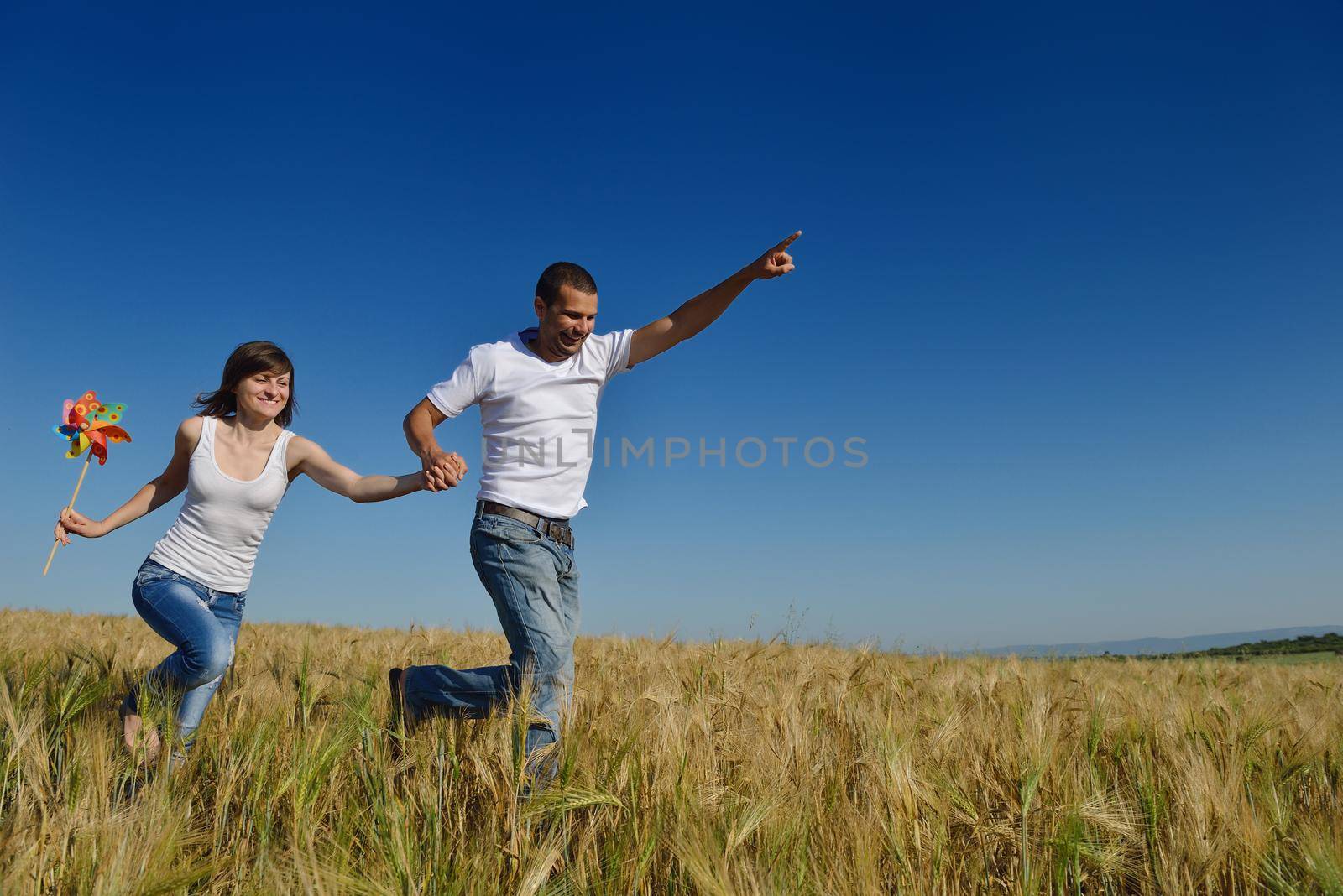 happy young couple in love have romance and fun at wheat field in summer