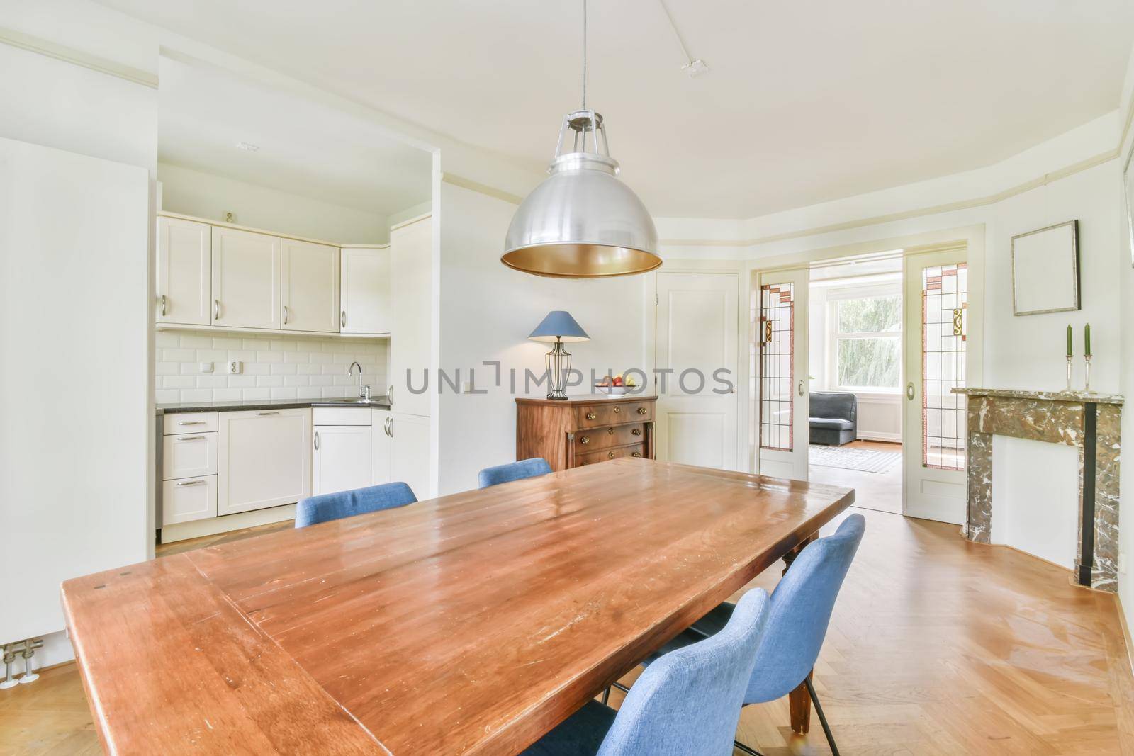 Comfortable dining room for four with an old wooden chest of drawers near the wall