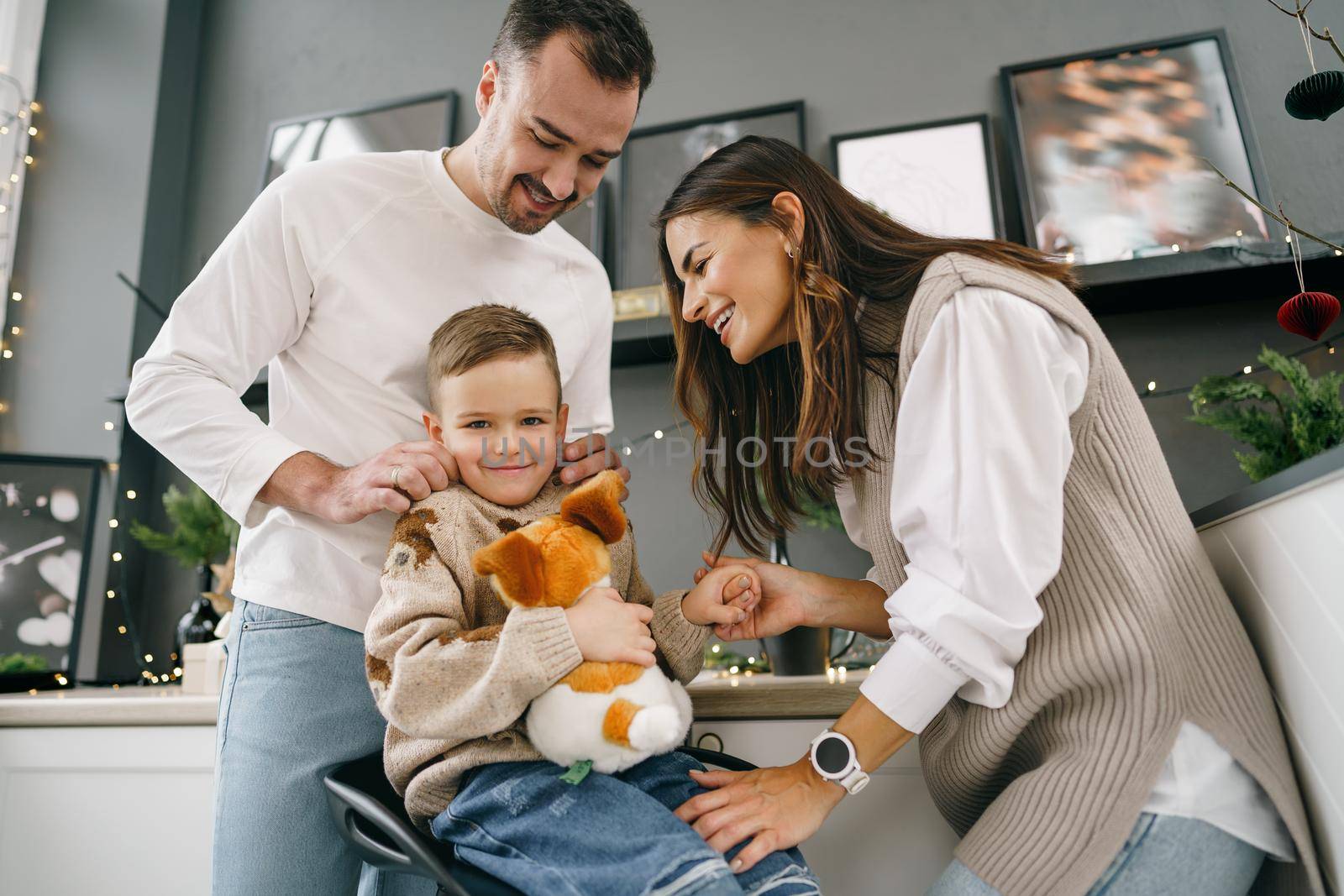 Happy young family spending time together in kitchen at home at Christmas holidays