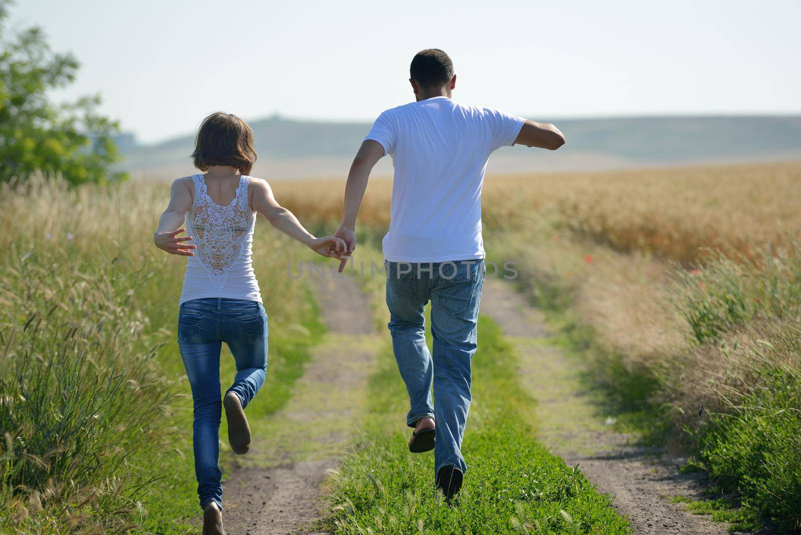 happy young couple in love have romance and fun at wheat field in summer