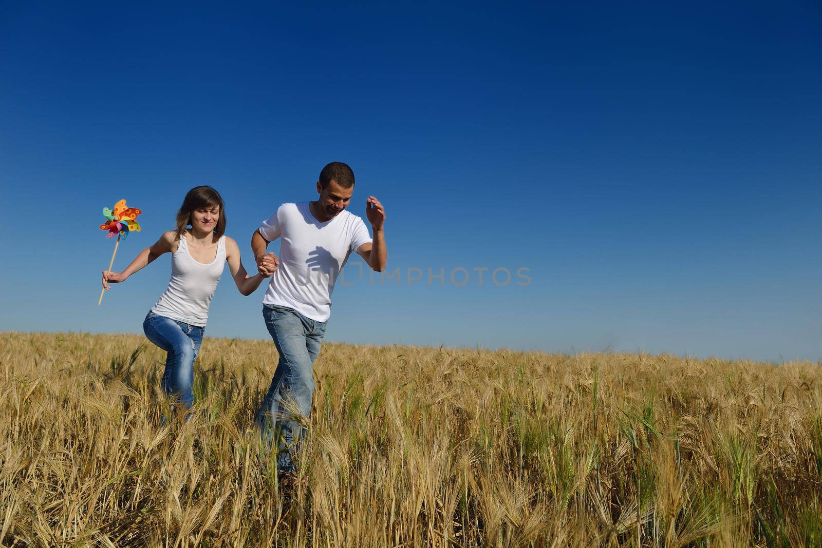 happy young couple in love have romance and fun at wheat field in summer