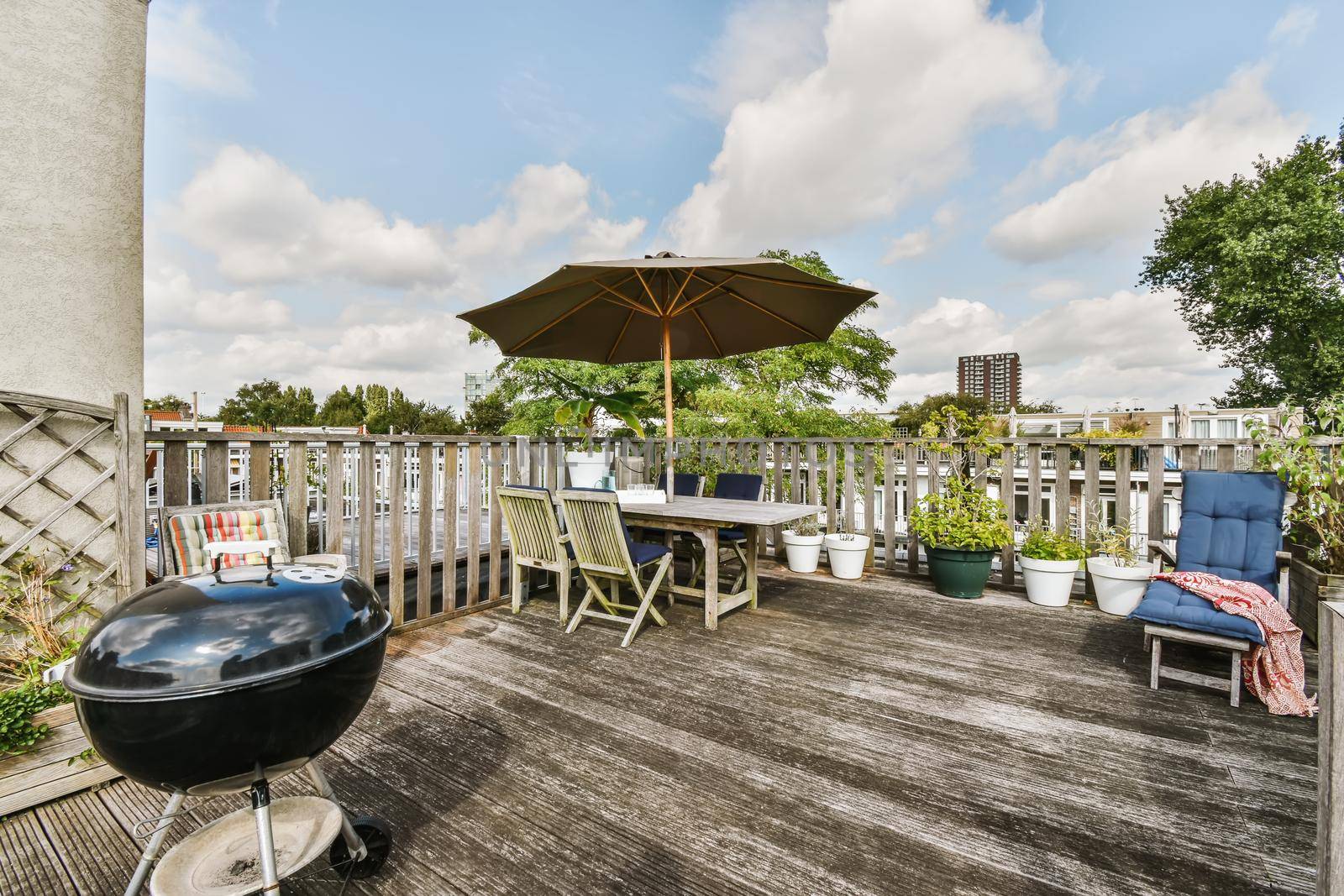 Exterior of the roof of the house with a delightful design with comfortable sun loungers and a table