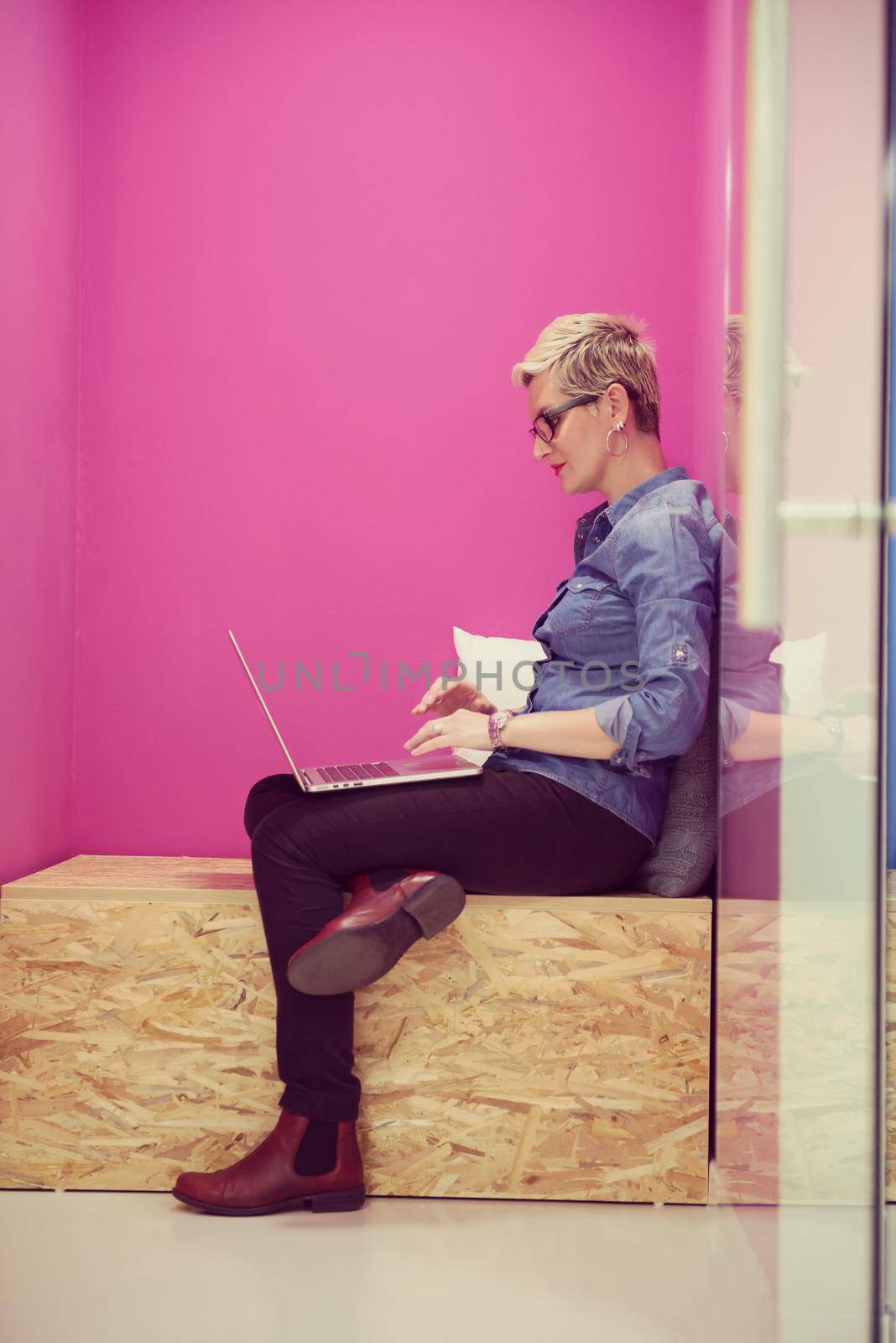 young woman in crative box working on laptop computer, startup business modern office room  interior