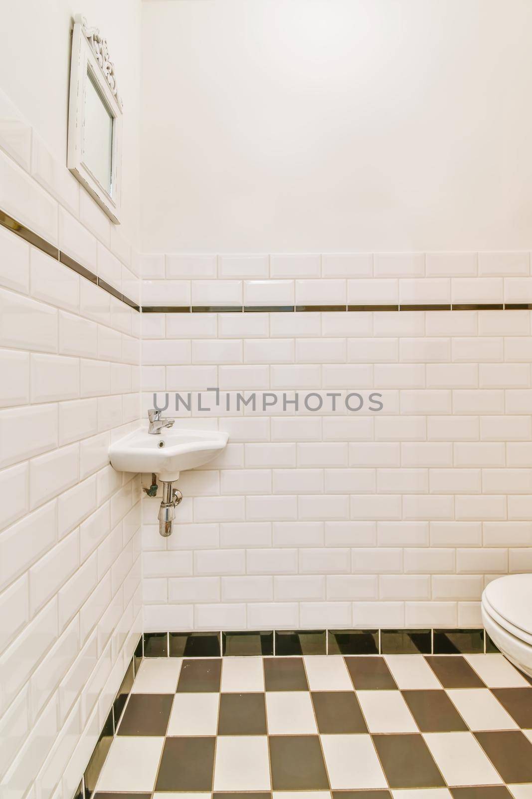 Small restroom with black and white checkerboard floor