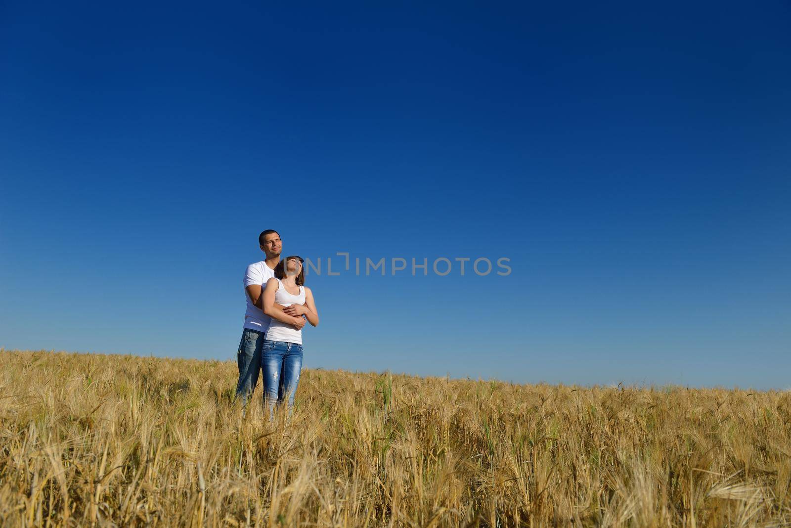 happy young couple in love have romance and fun at wheat field in summer