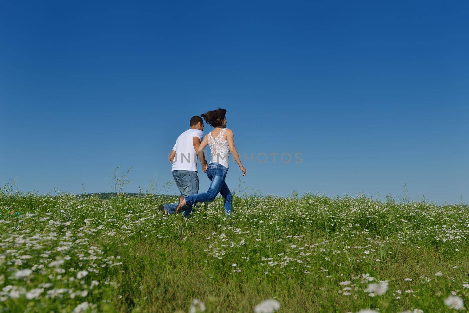 happy young couple in love have romance and fun at wheat field in summer