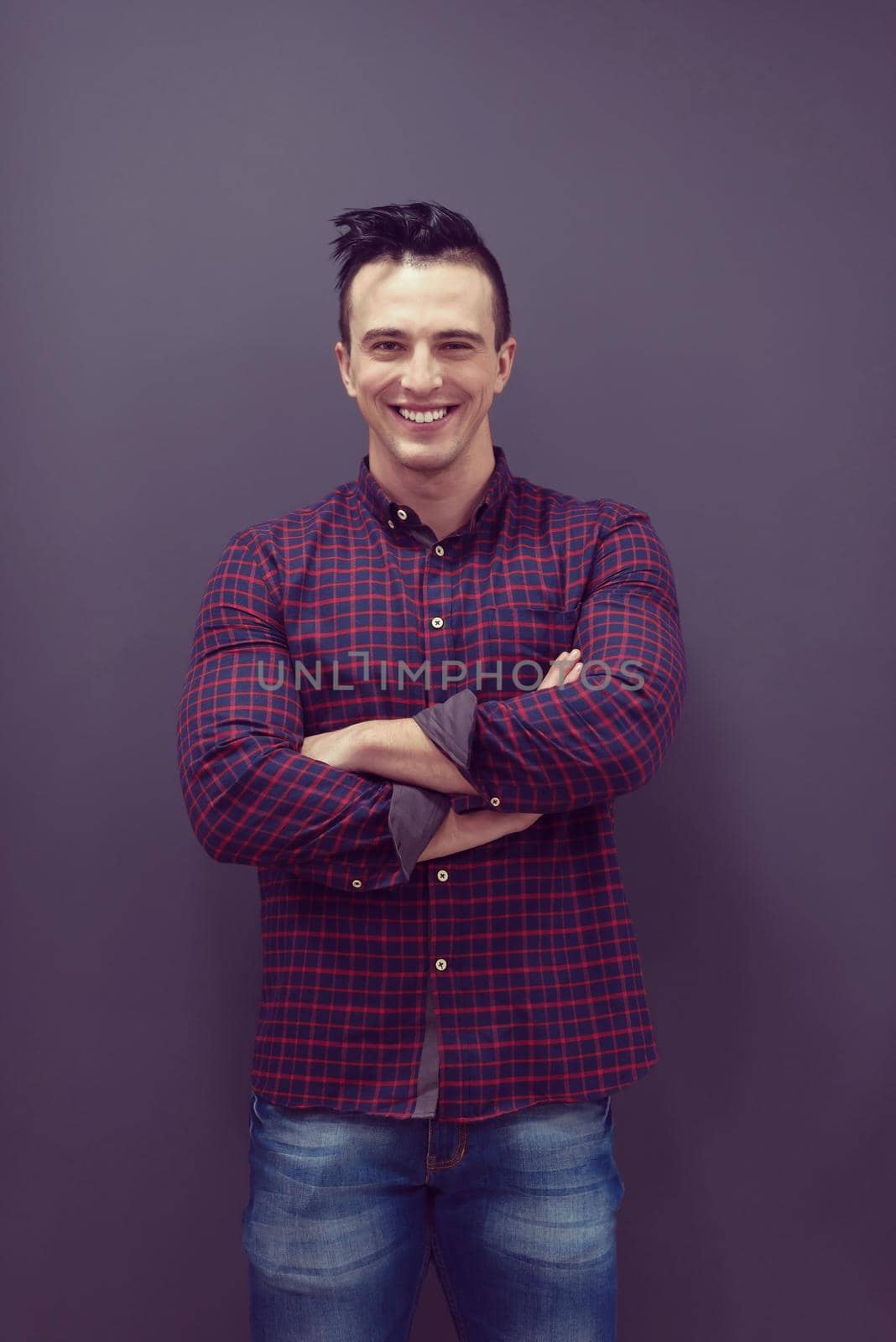 portrait of young business man in casual clothes grey wall in background