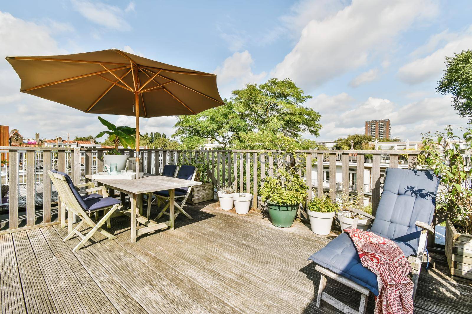 Exterior of the roof of the house with a delightful design with comfortable sun loungers and a table