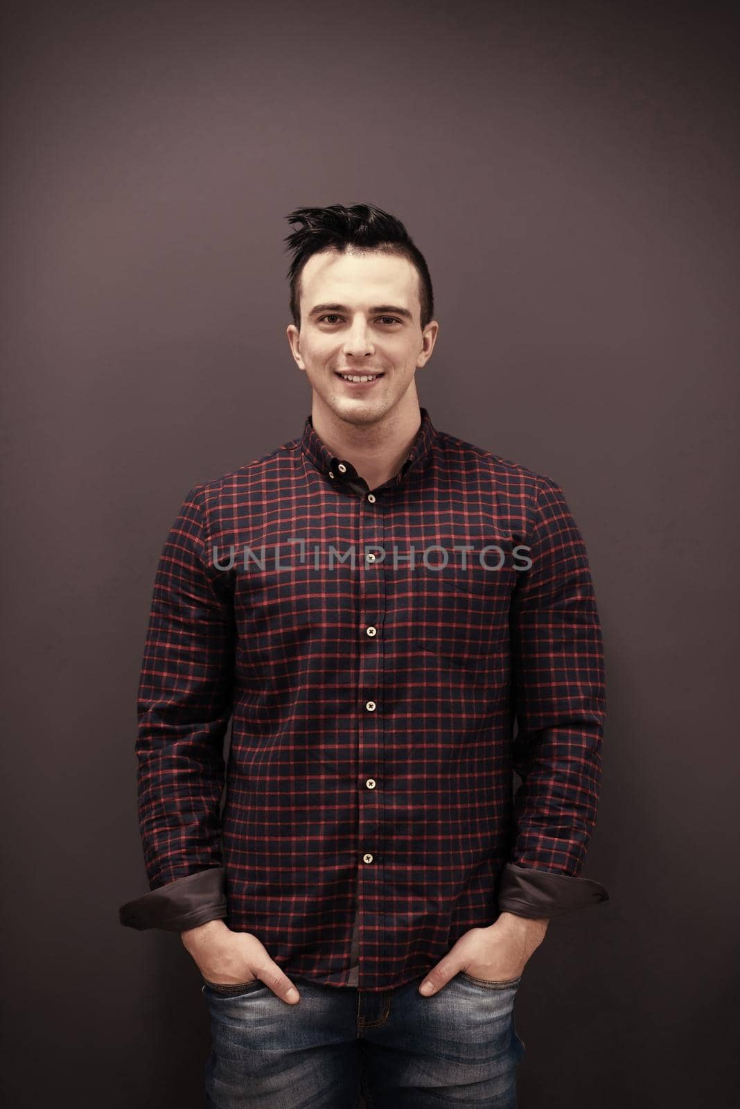 portrait of young business man in casual clothes grey wall in background