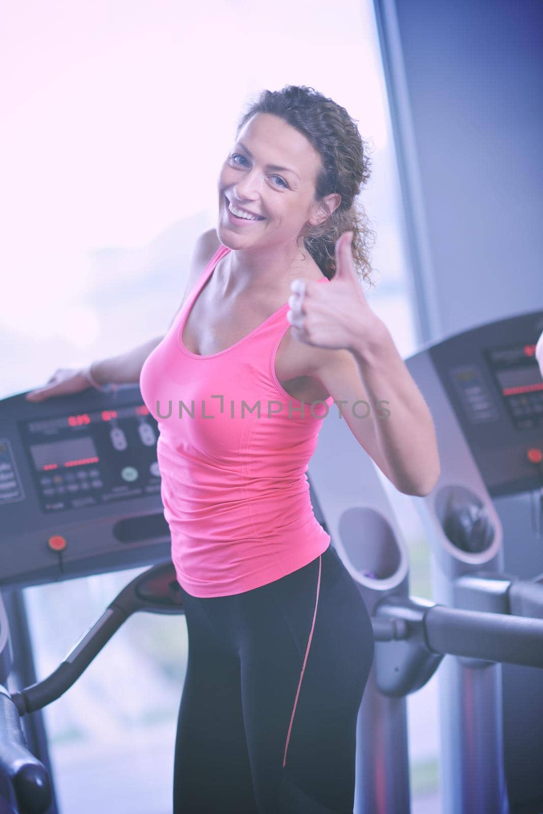 sport, fitness, lifestyle, technology and people concept - smiling woman exercising on treadmill in gym