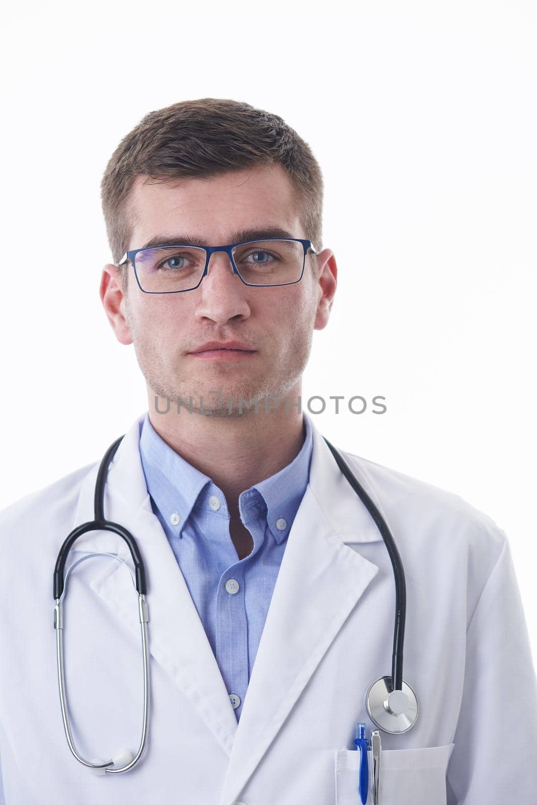 Coronavirus covid-19 pandemic Portrait of hero in white coat.  Cheerful smiling young doctor with stethoscope in medical hospital standing against white  background.