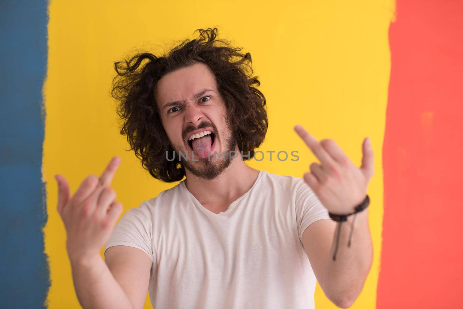 Portrait of a beautiful  young man with funny hair over color background with copyspace expressing different emotions