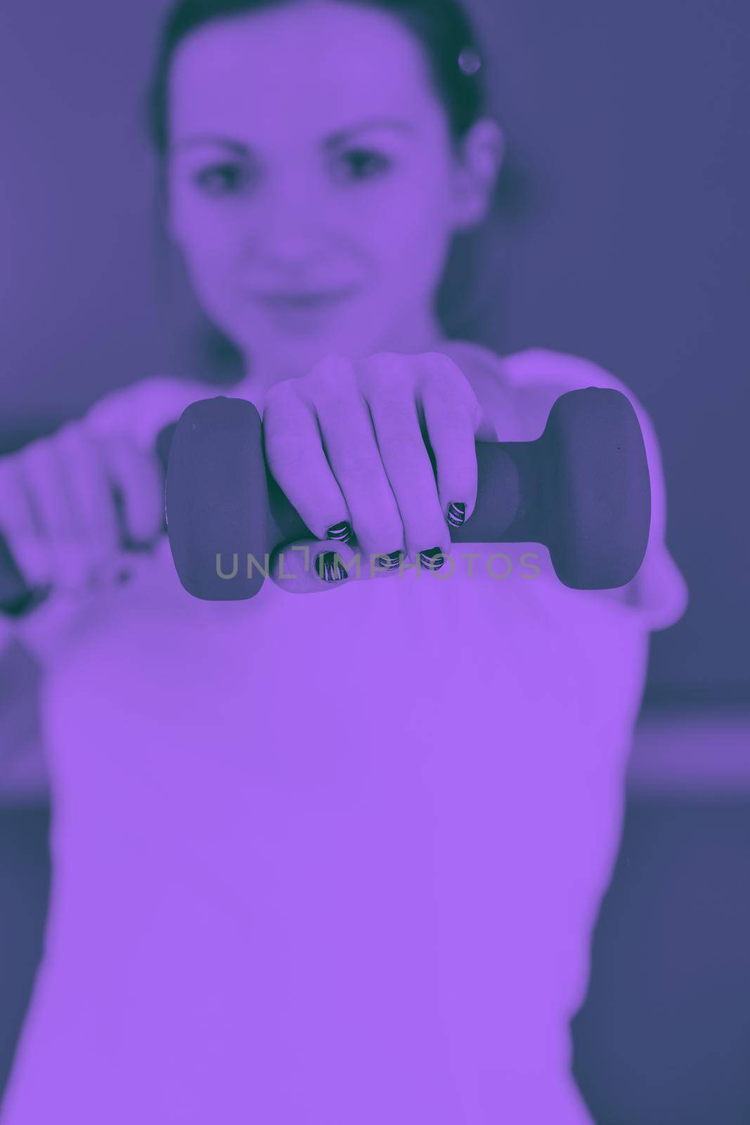 beaudiful young woman fitness workout with weights at sport club duo tone