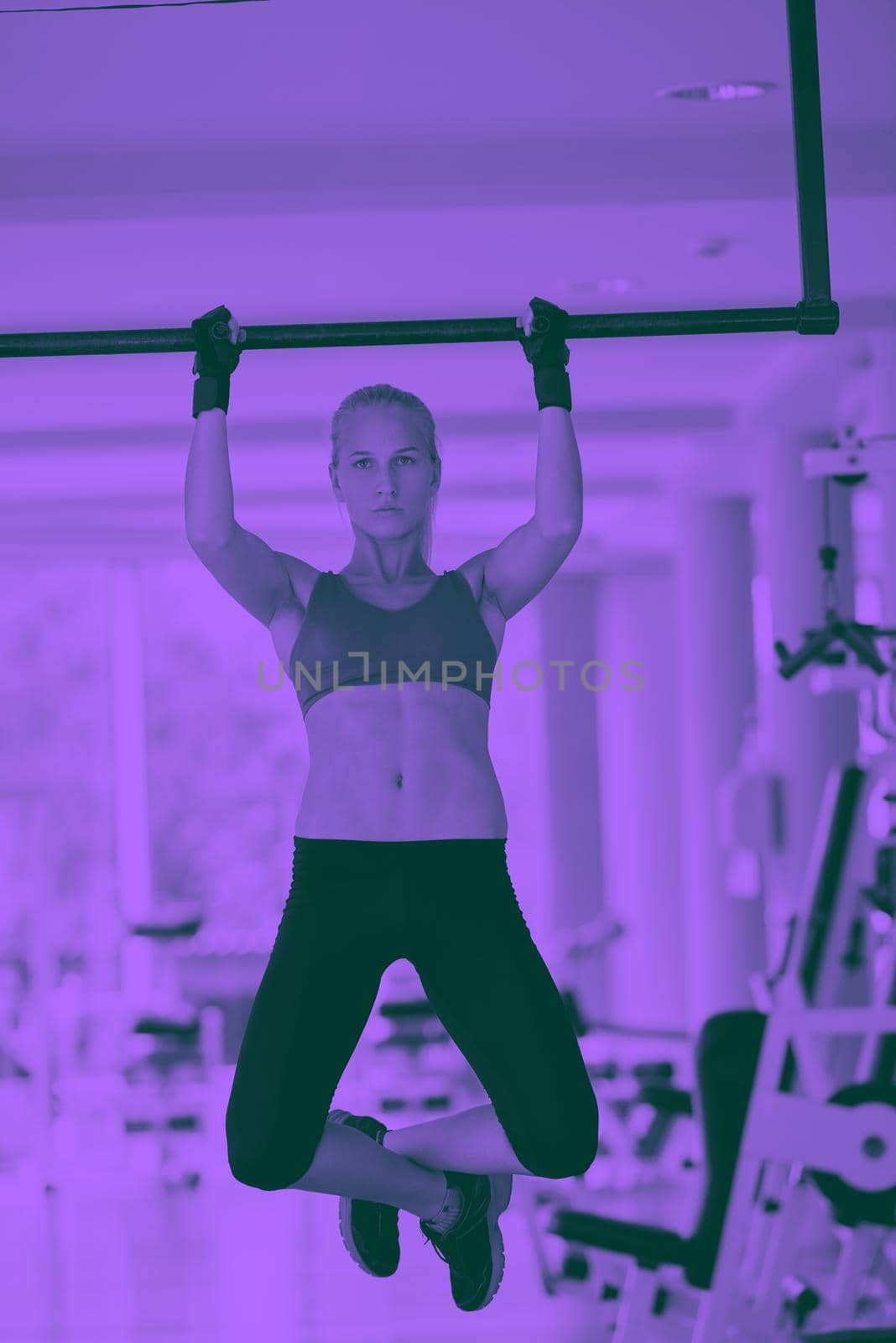 healthy lifestile, young woman in fitness gym lifting on bar and working on her back and hands muscles duo tone