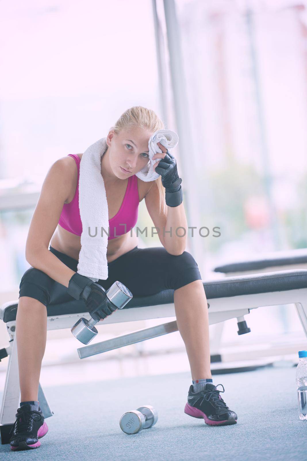 young woman exercise with dumbells by dotshock